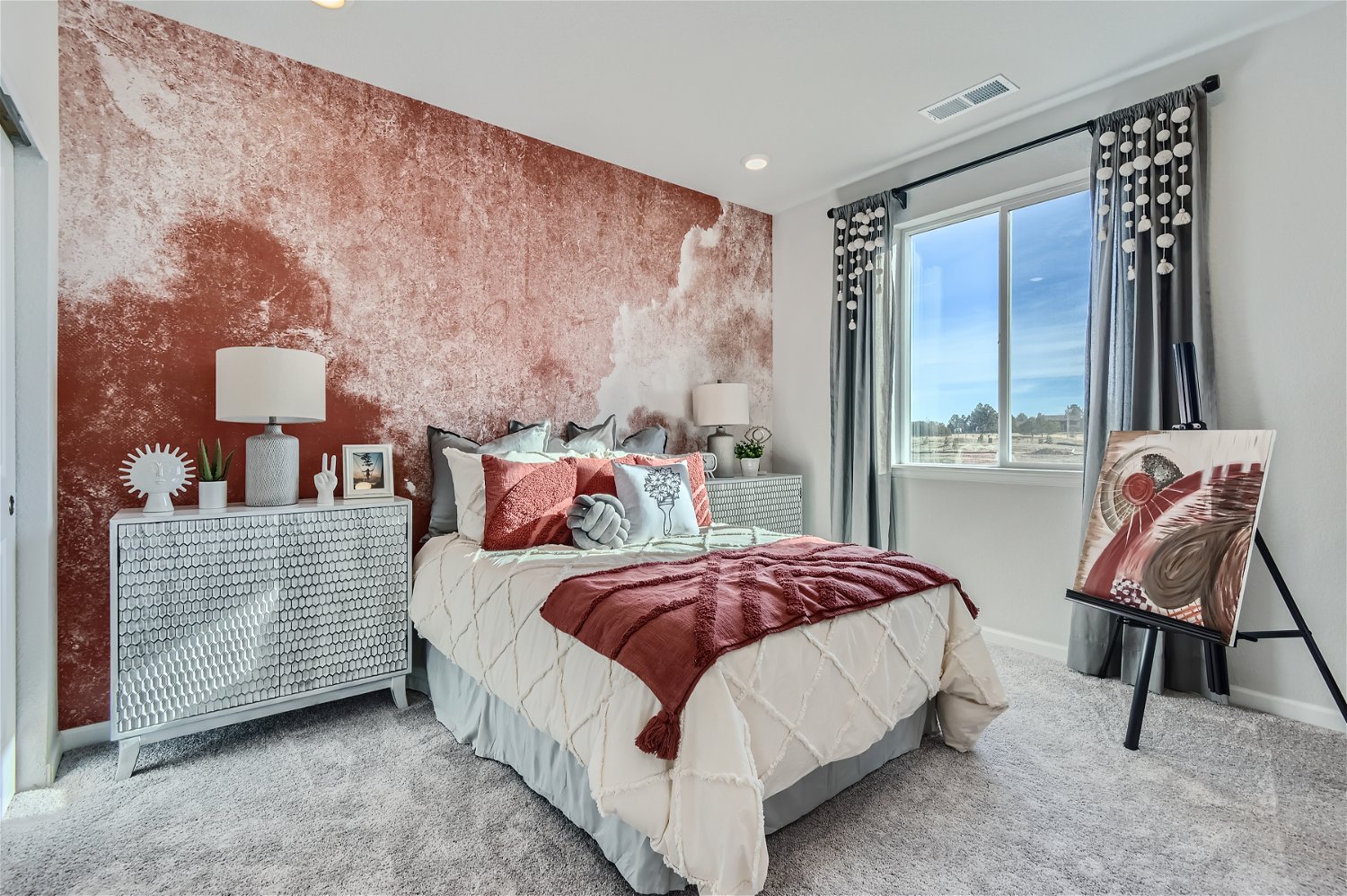 A bedroom with a bed and a chair.