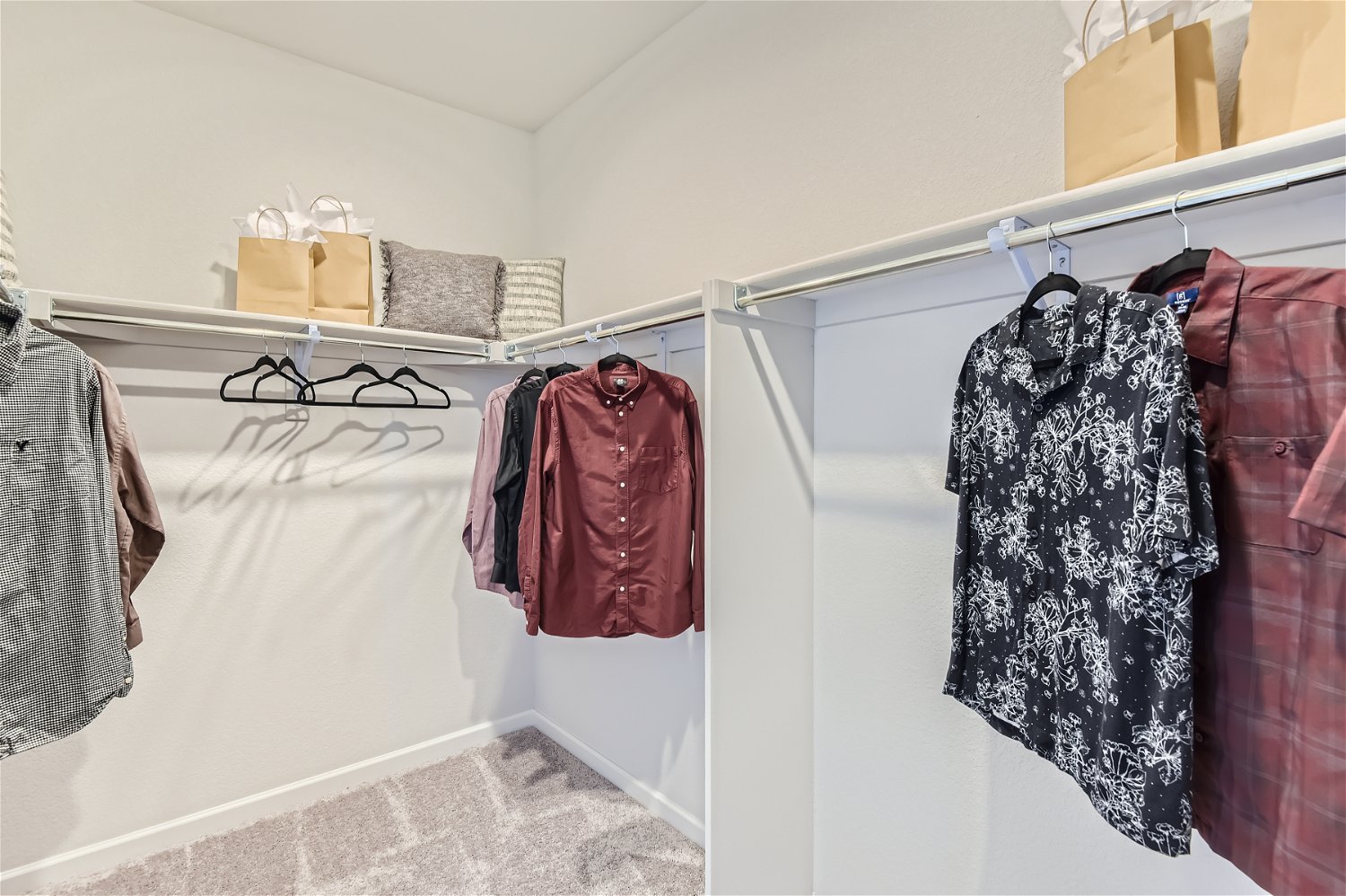 A closet with clothes and a coat rack.