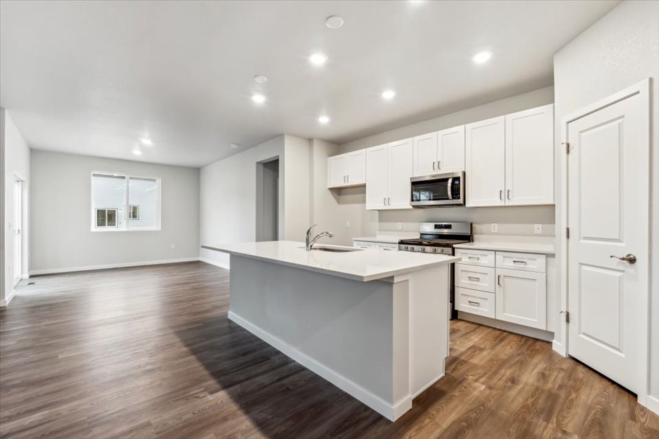 A kitchen with white cabinets.