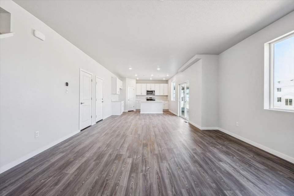 A long hallway with white doors.