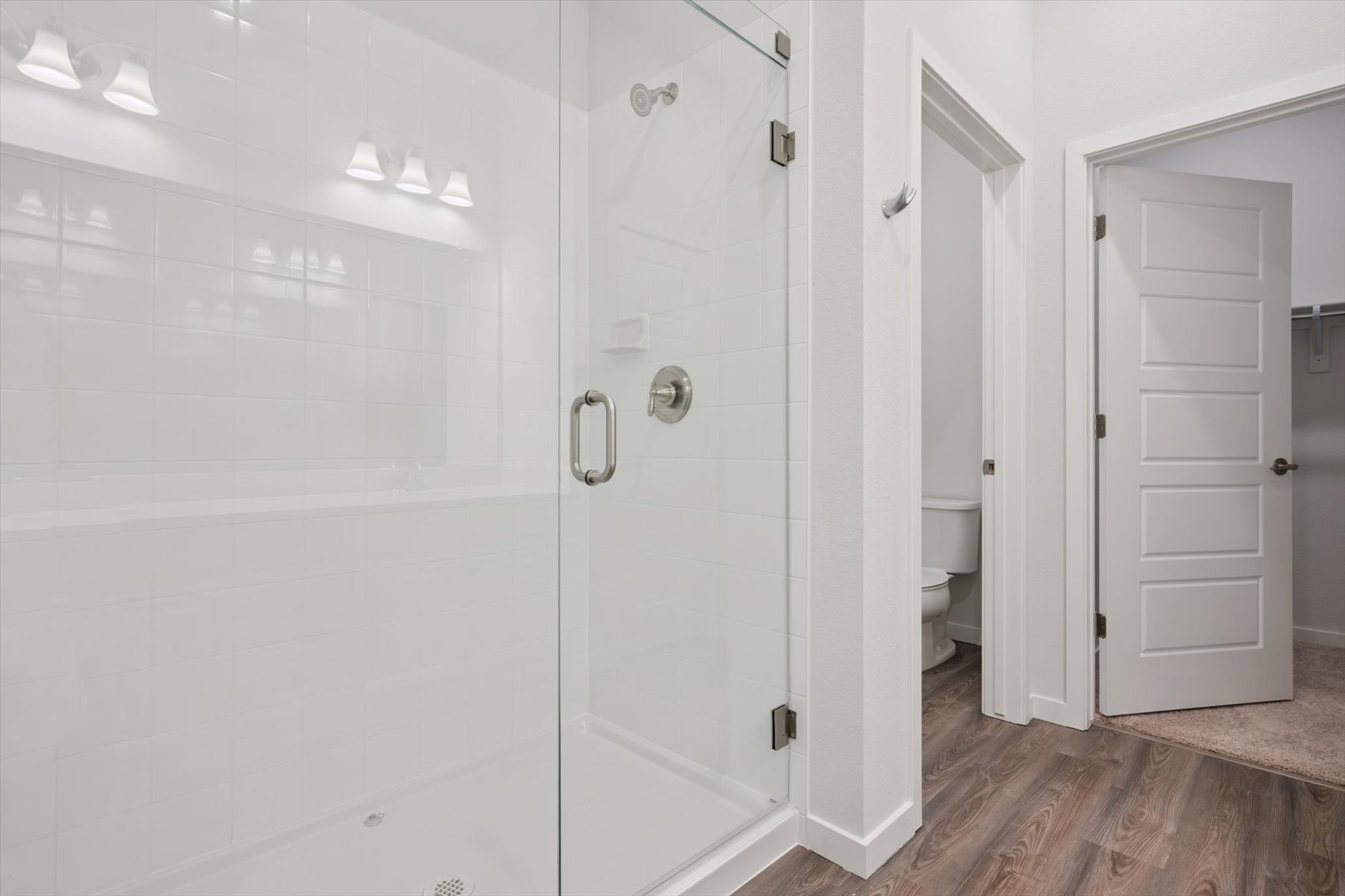 A bathroom with white cabinets.
