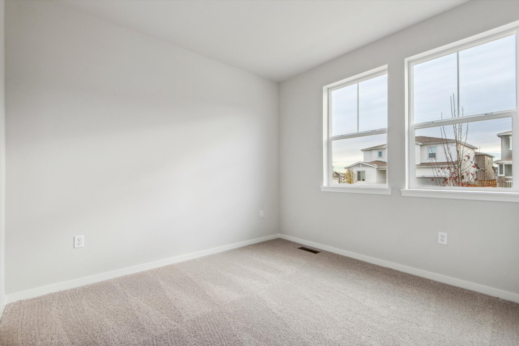 A room with a window and a carpet.