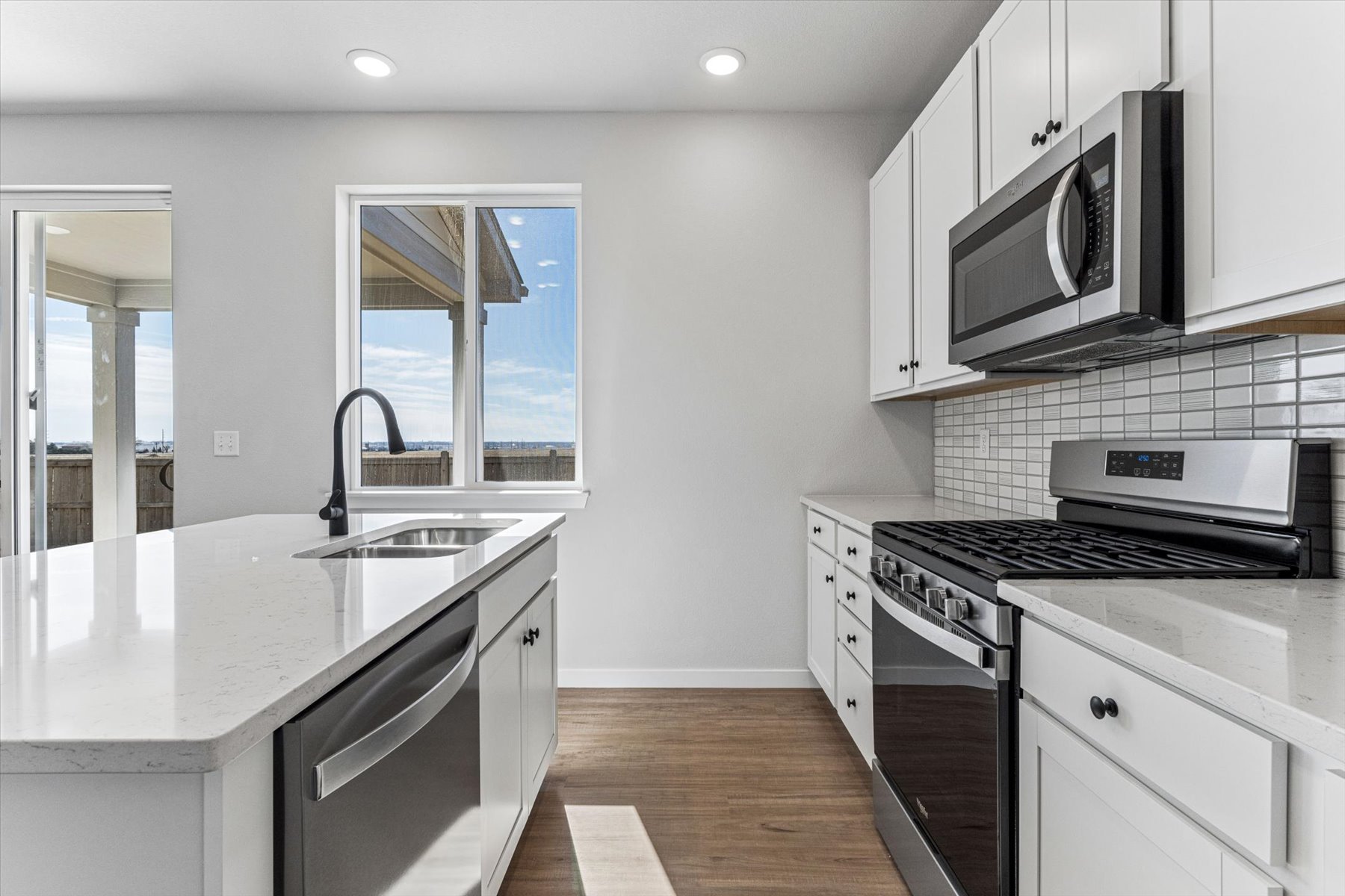 A kitchen with white cabinets.