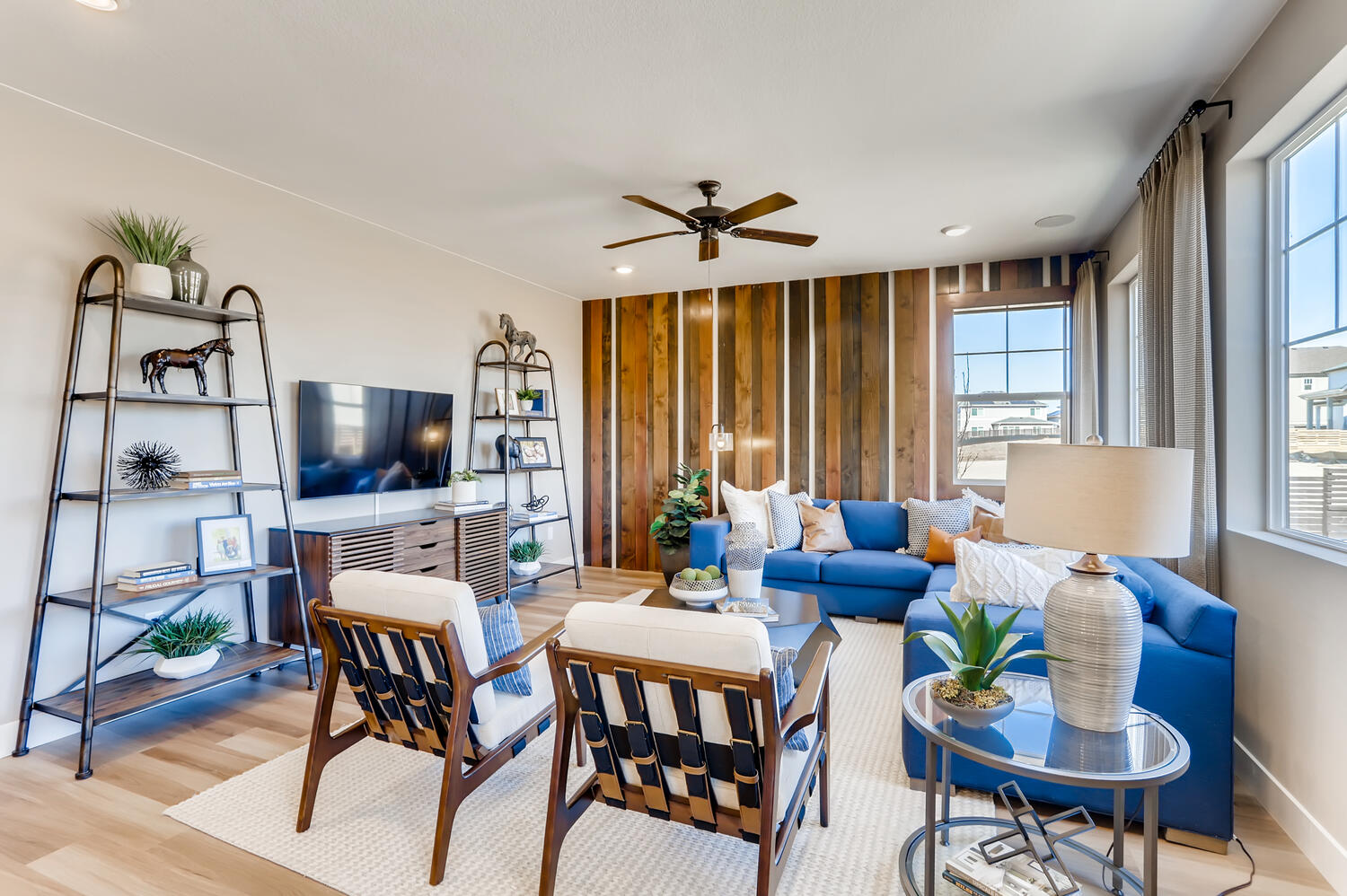 A living room with a blue couch and a table.
