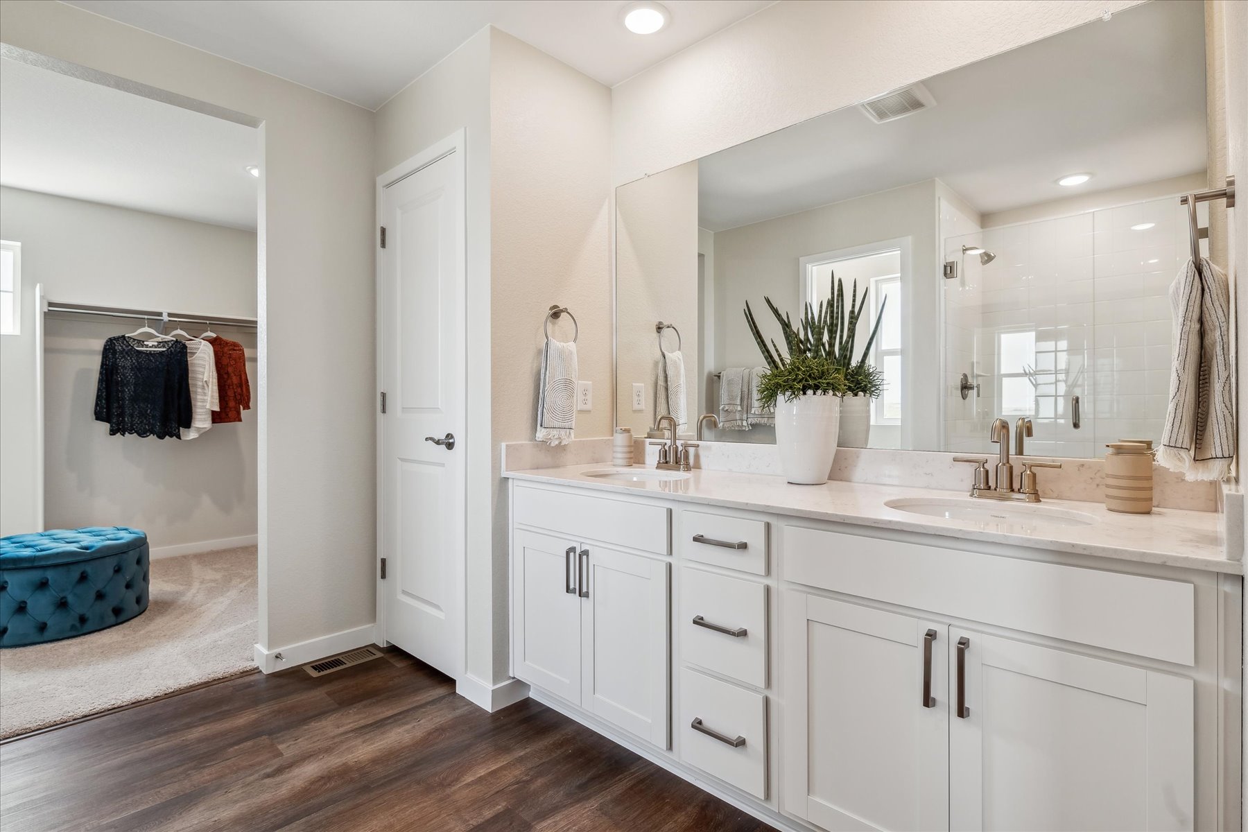 A bathroom with white cabinets.