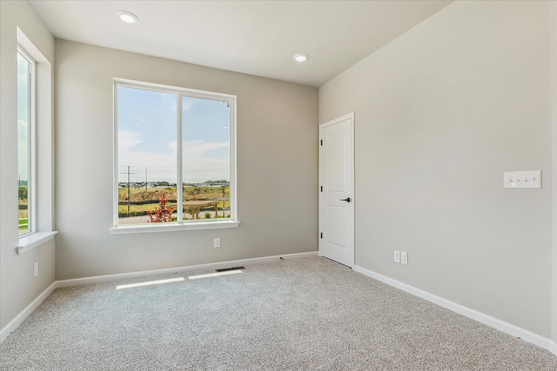 A room with a window and a door.