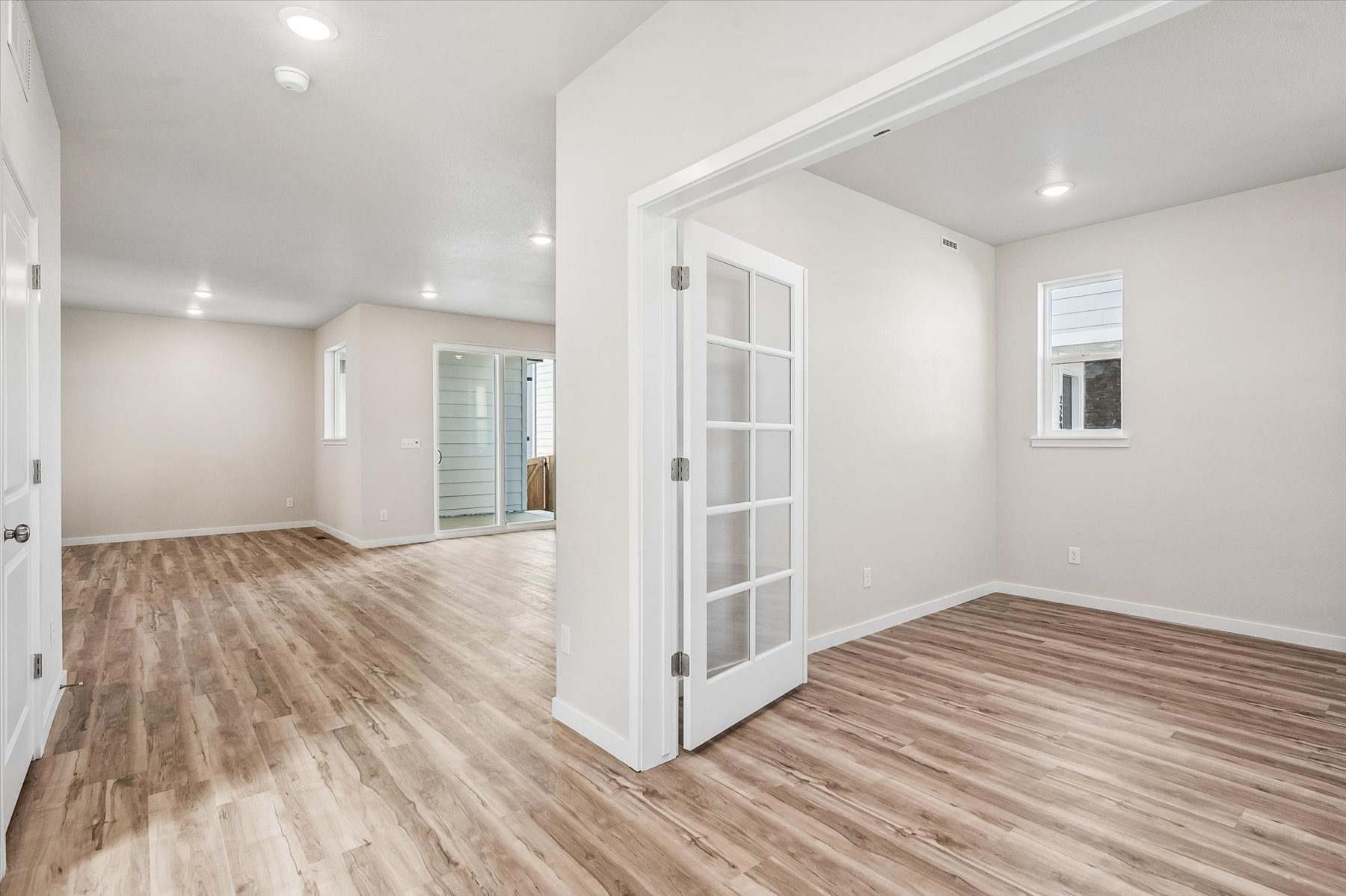 A room with a wood floor and white walls.