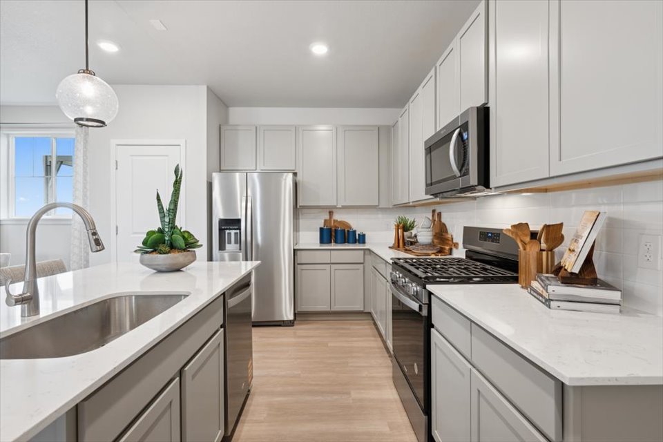 A kitchen with white cabinets.