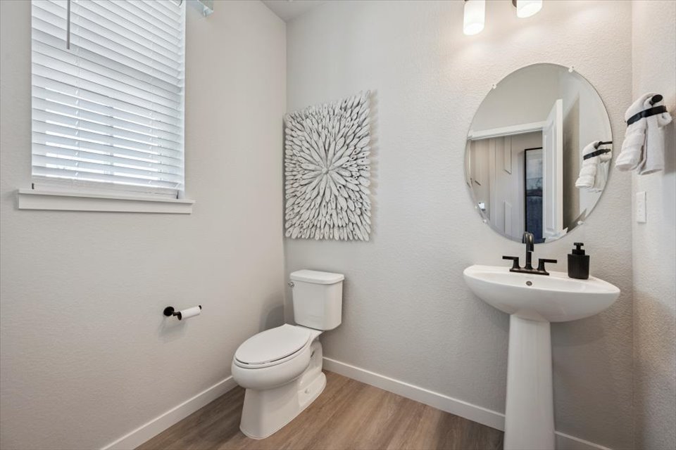 A bathroom with a mirror and sink.