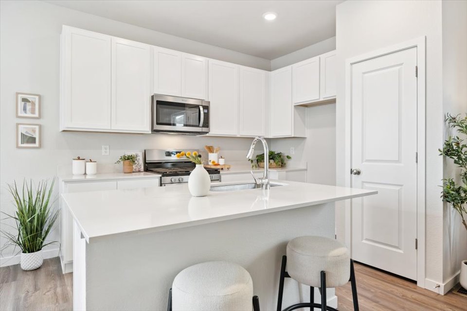 A kitchen with white cabinets.