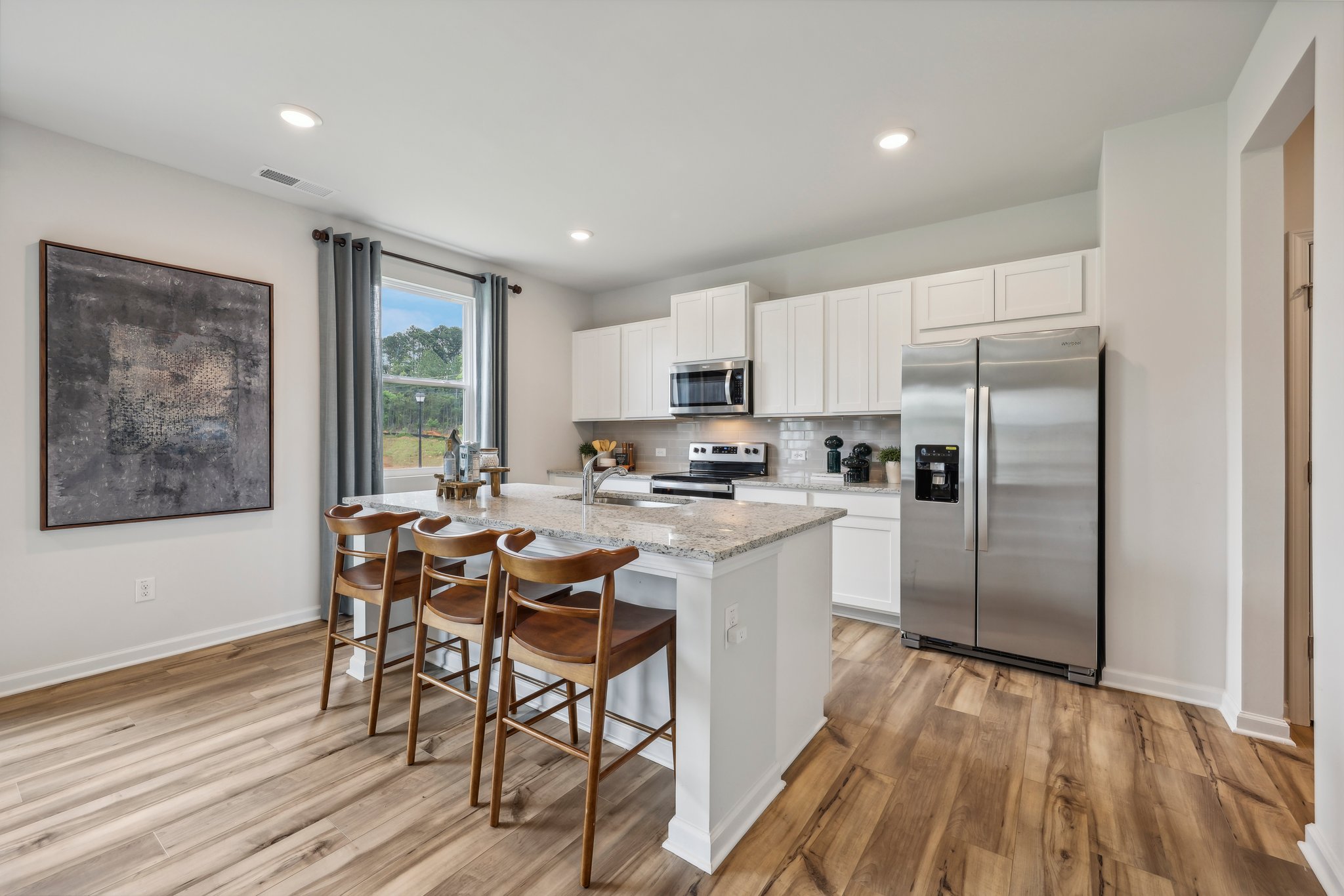 A kitchen with a table and chairs.