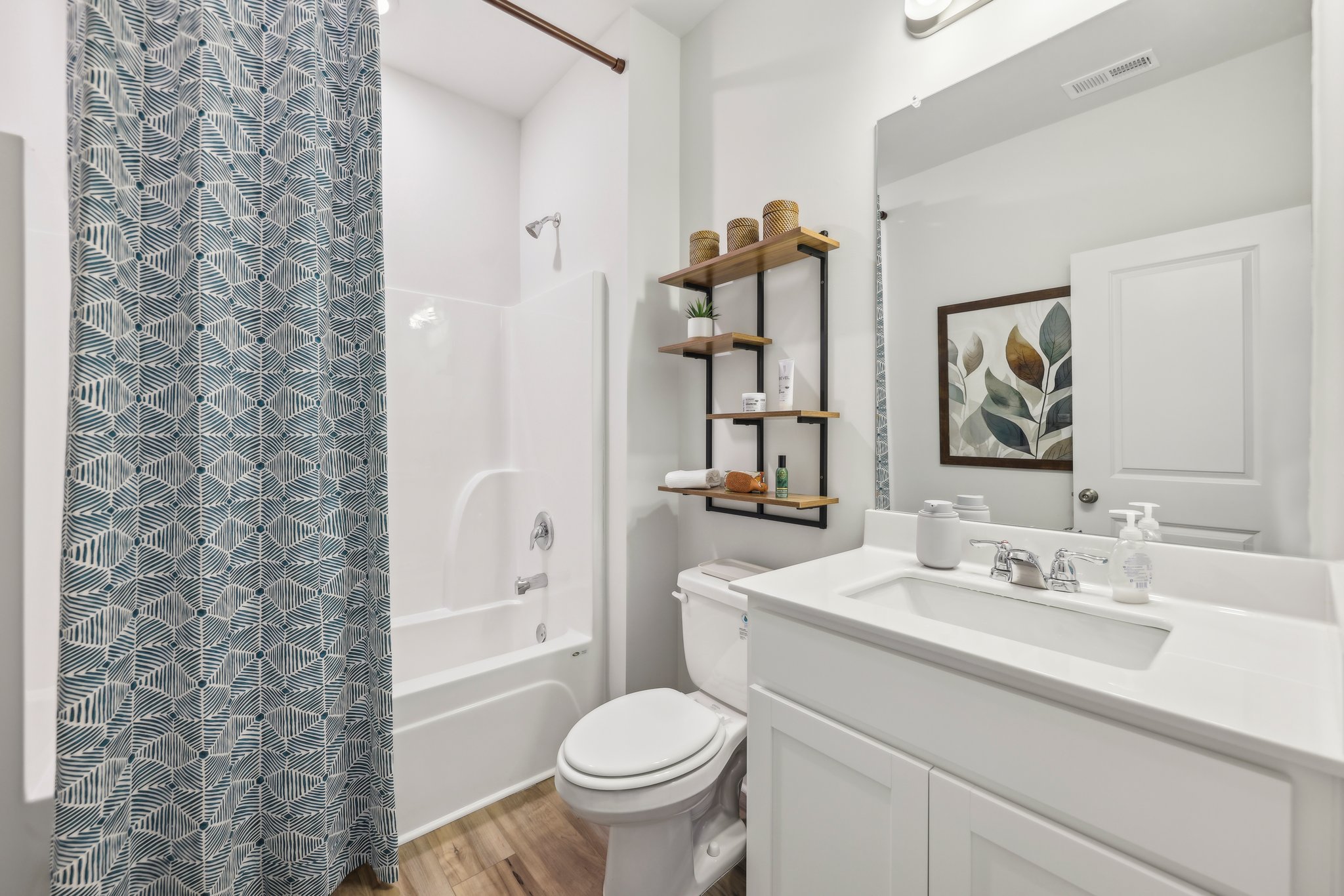 A bathroom with a tub sink and toilet.