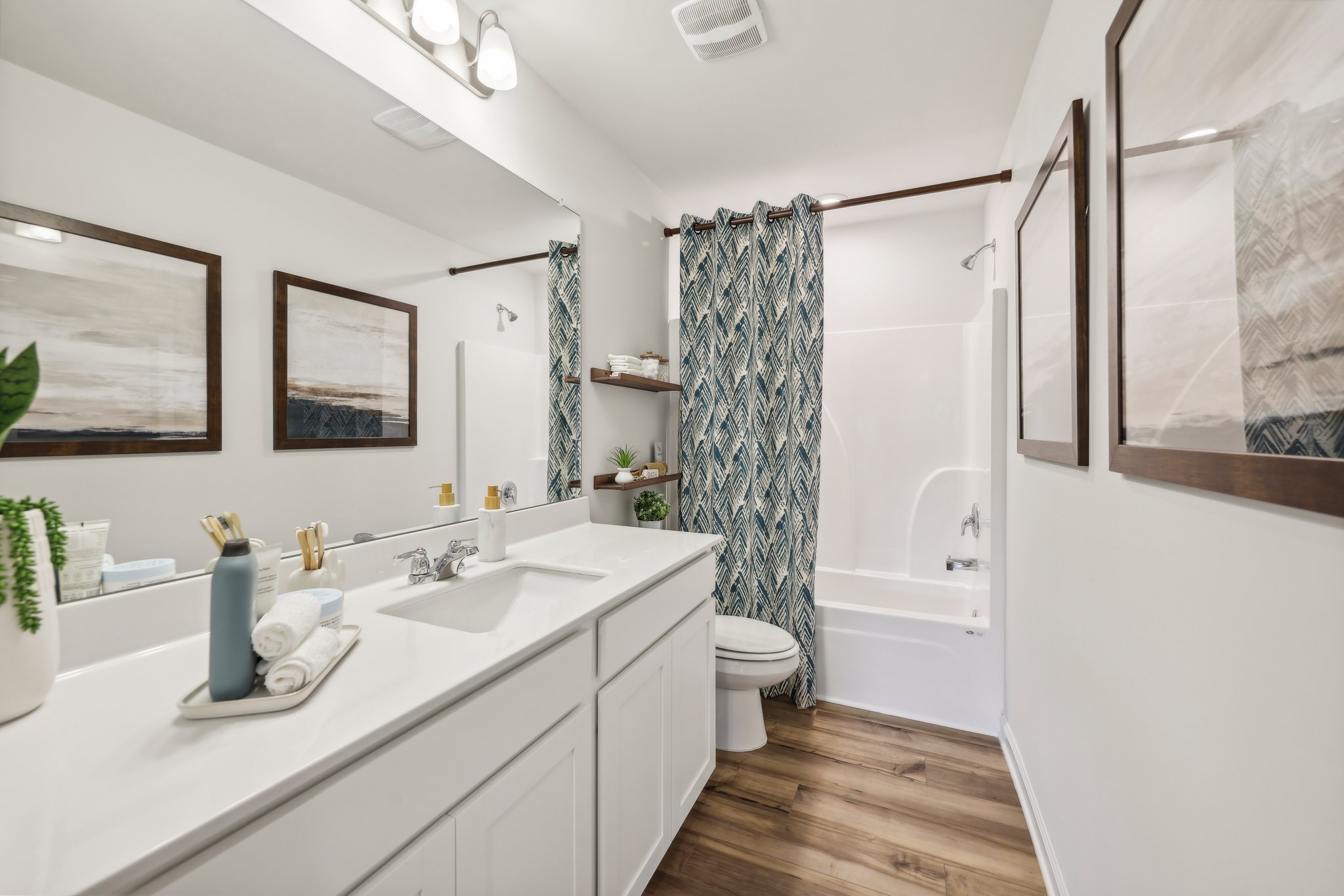 A bathroom with a tub sink and toilet.