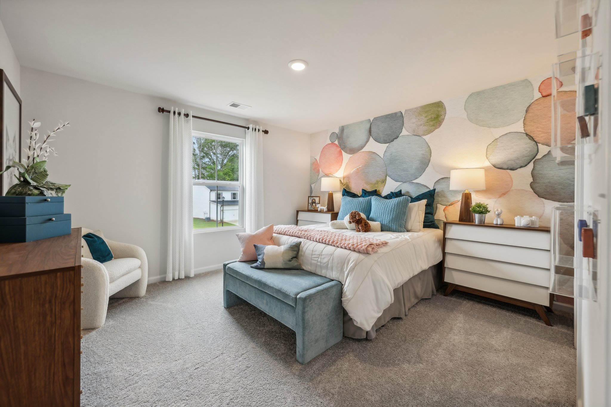 A bedroom with a bed and couches.