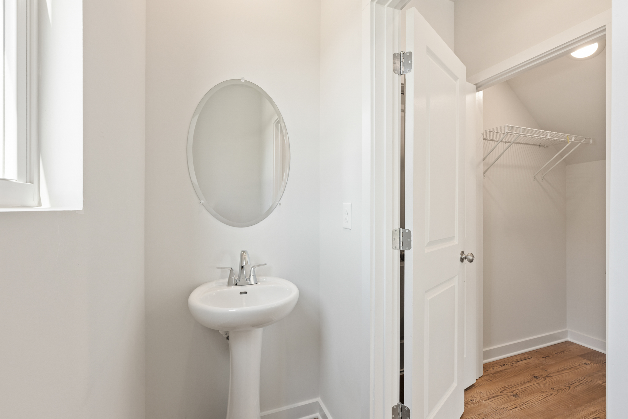 A bathroom with a mirror and sink.