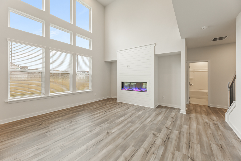 A room with a tv and a window.