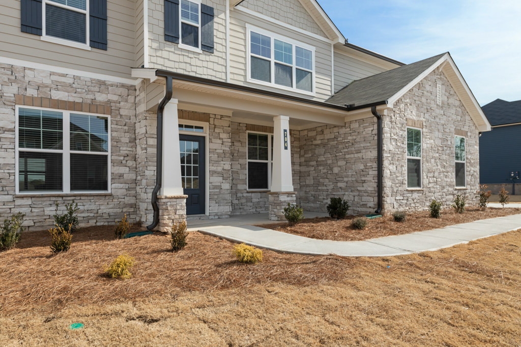 A house with a gravel driveway.