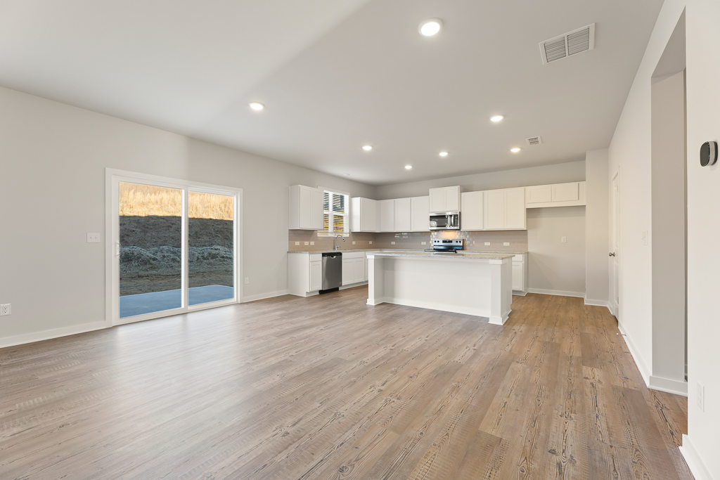 A large kitchen with white cabinets.