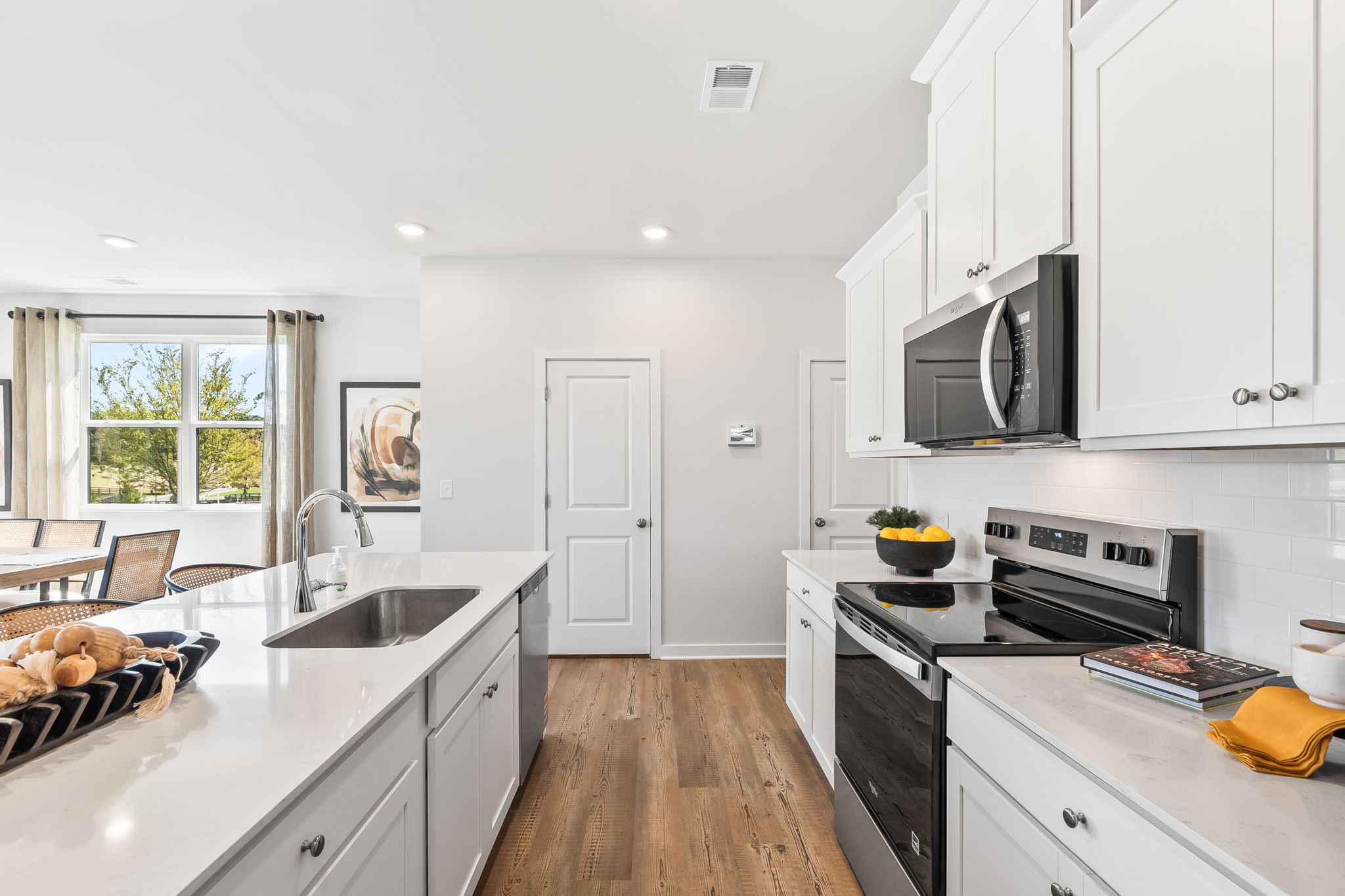 A kitchen with white cabinets.
