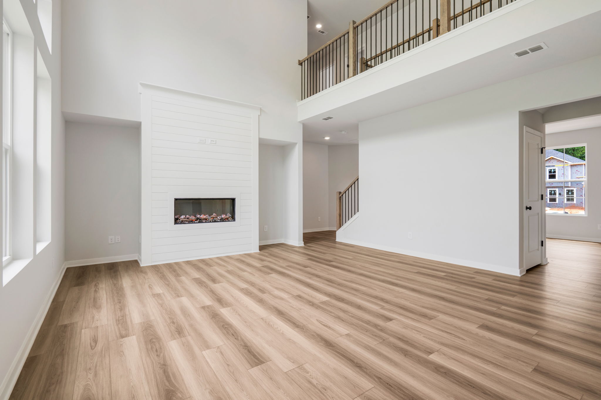 A room with a fireplace and wood floors.