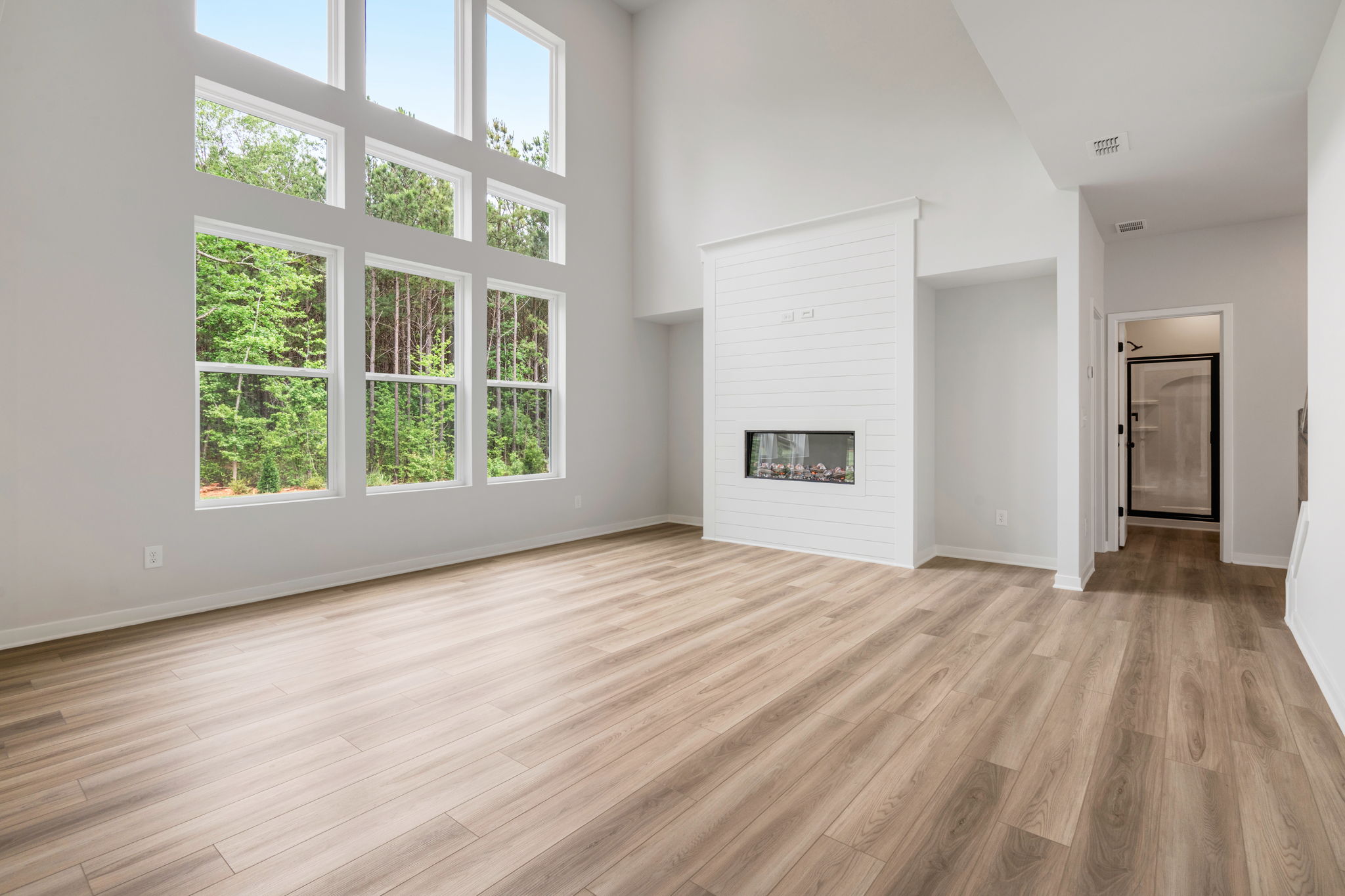 A room with a wood floor and windows.