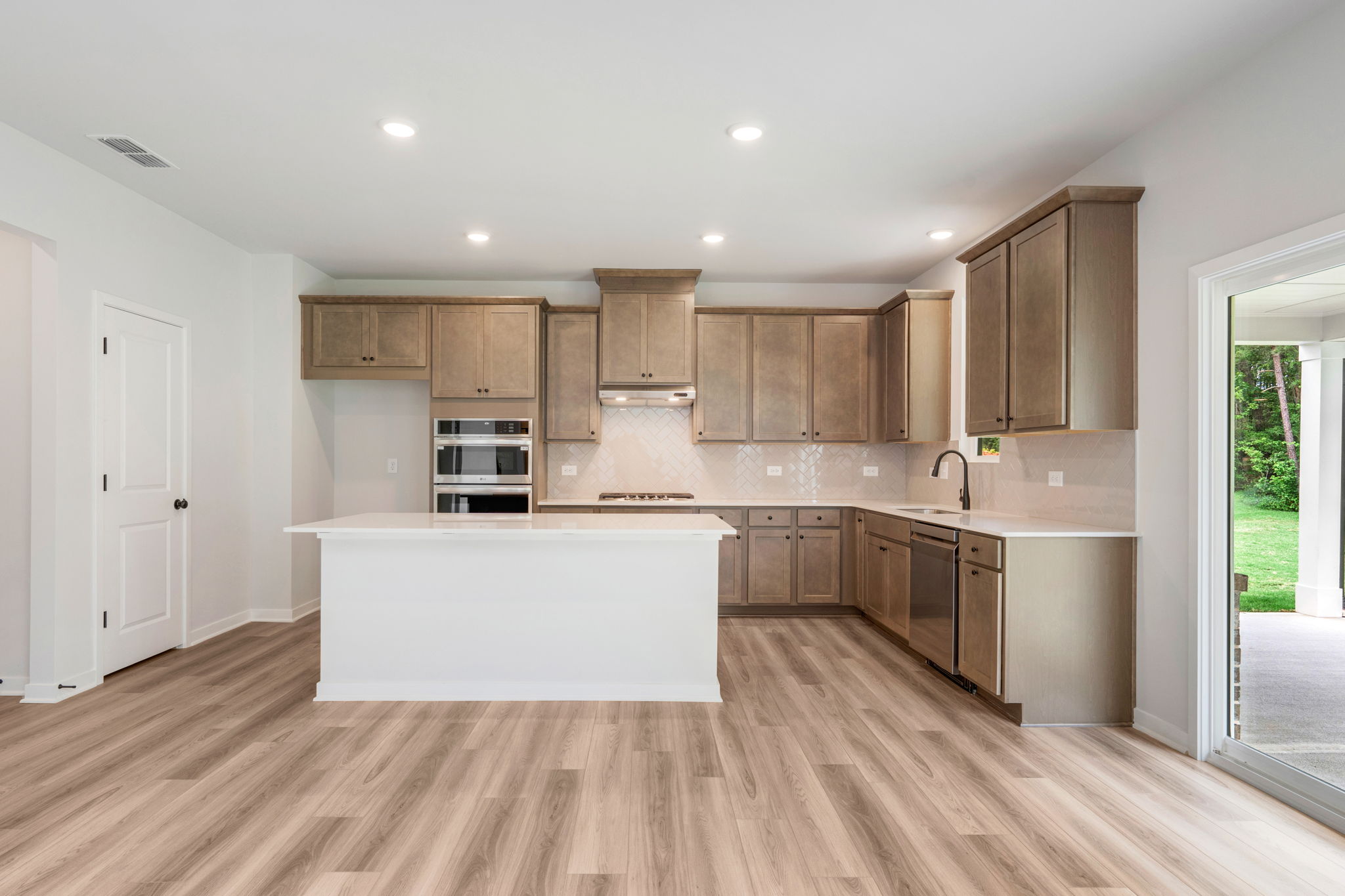 A kitchen with wooden cabinets.