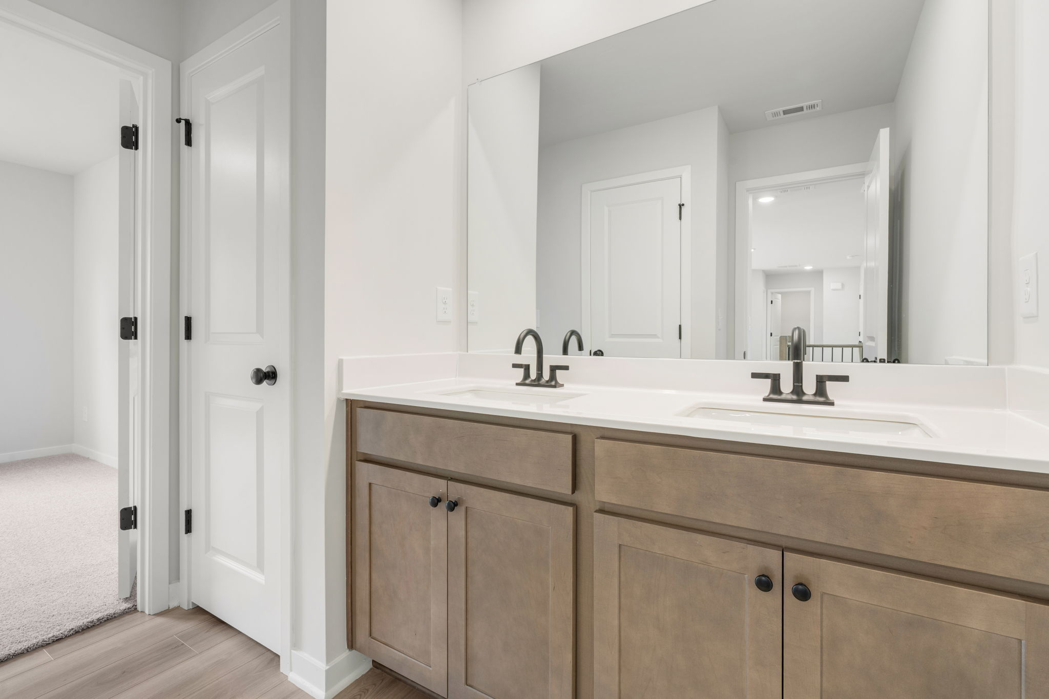 A bathroom with a large mirror.