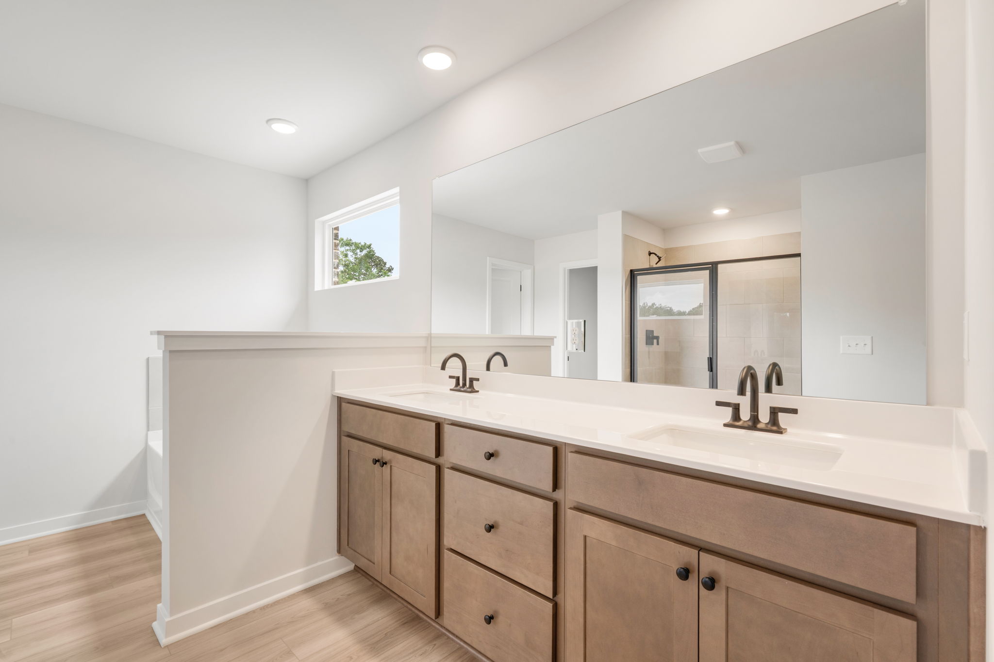 A bathroom with a large mirror.
