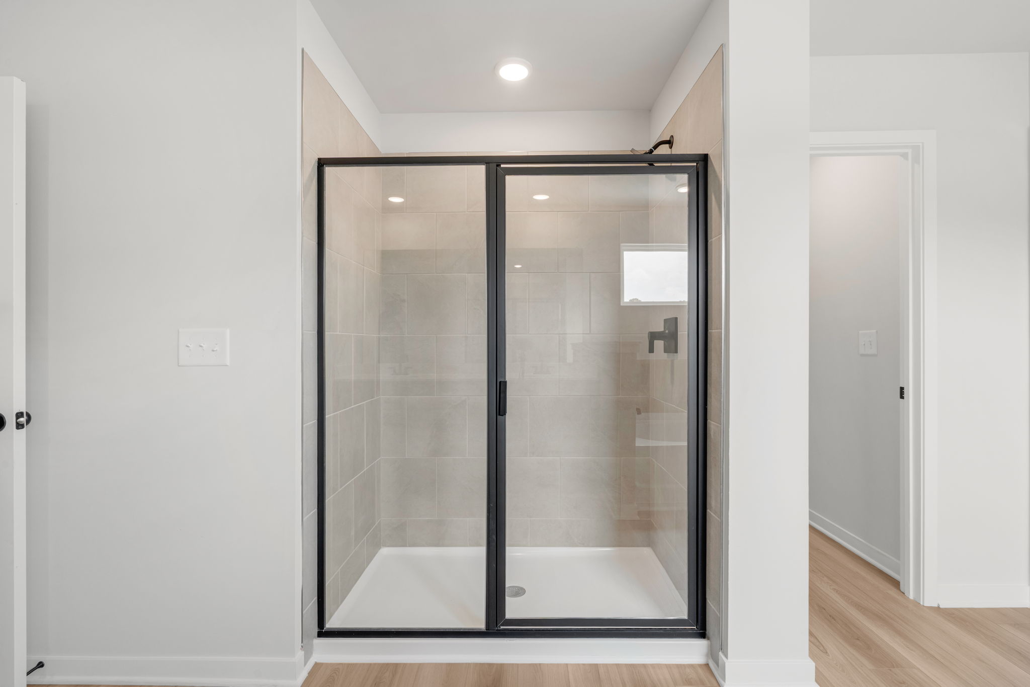 A glass shower in a room.