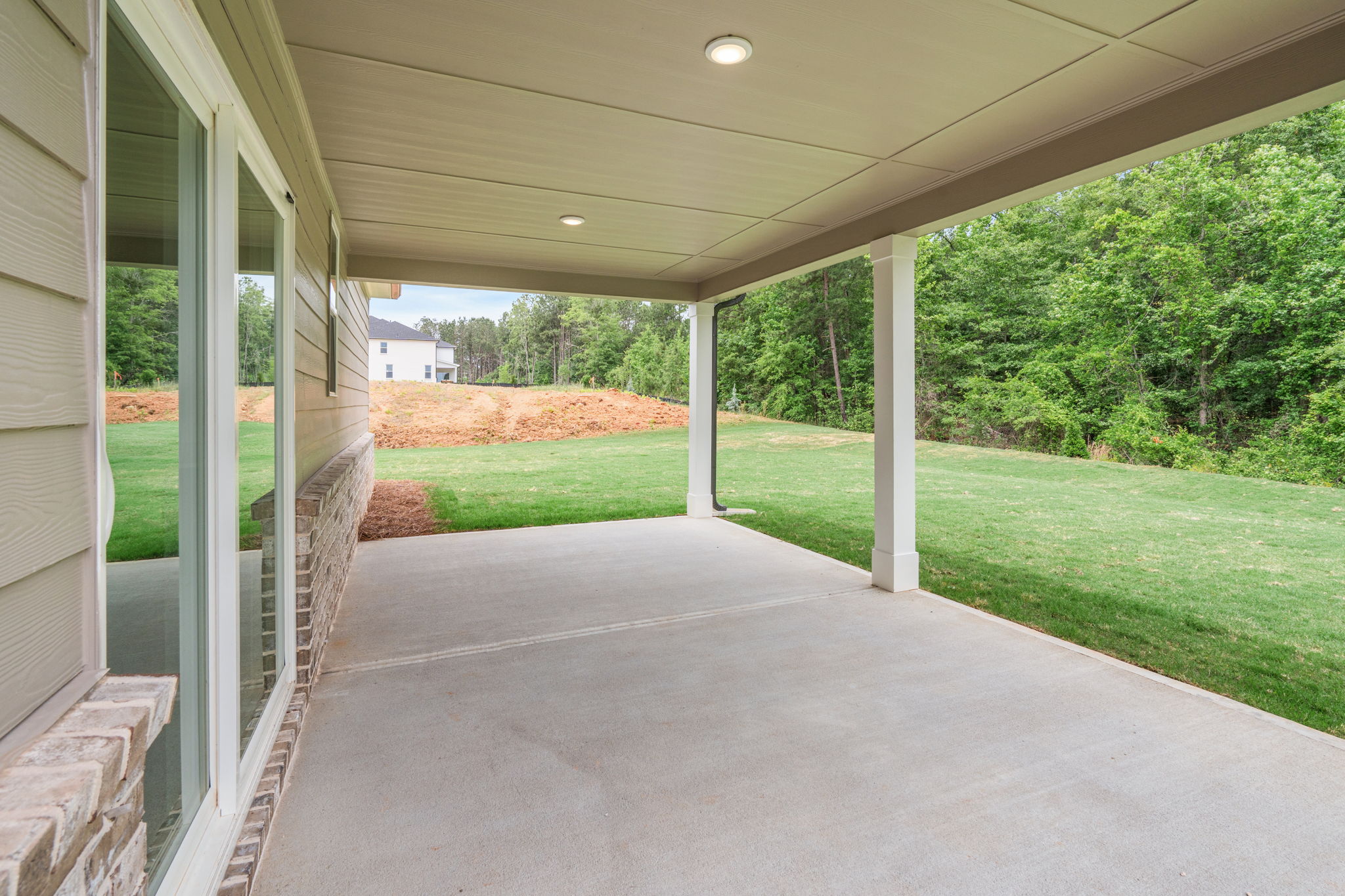A walkway with grass and trees.