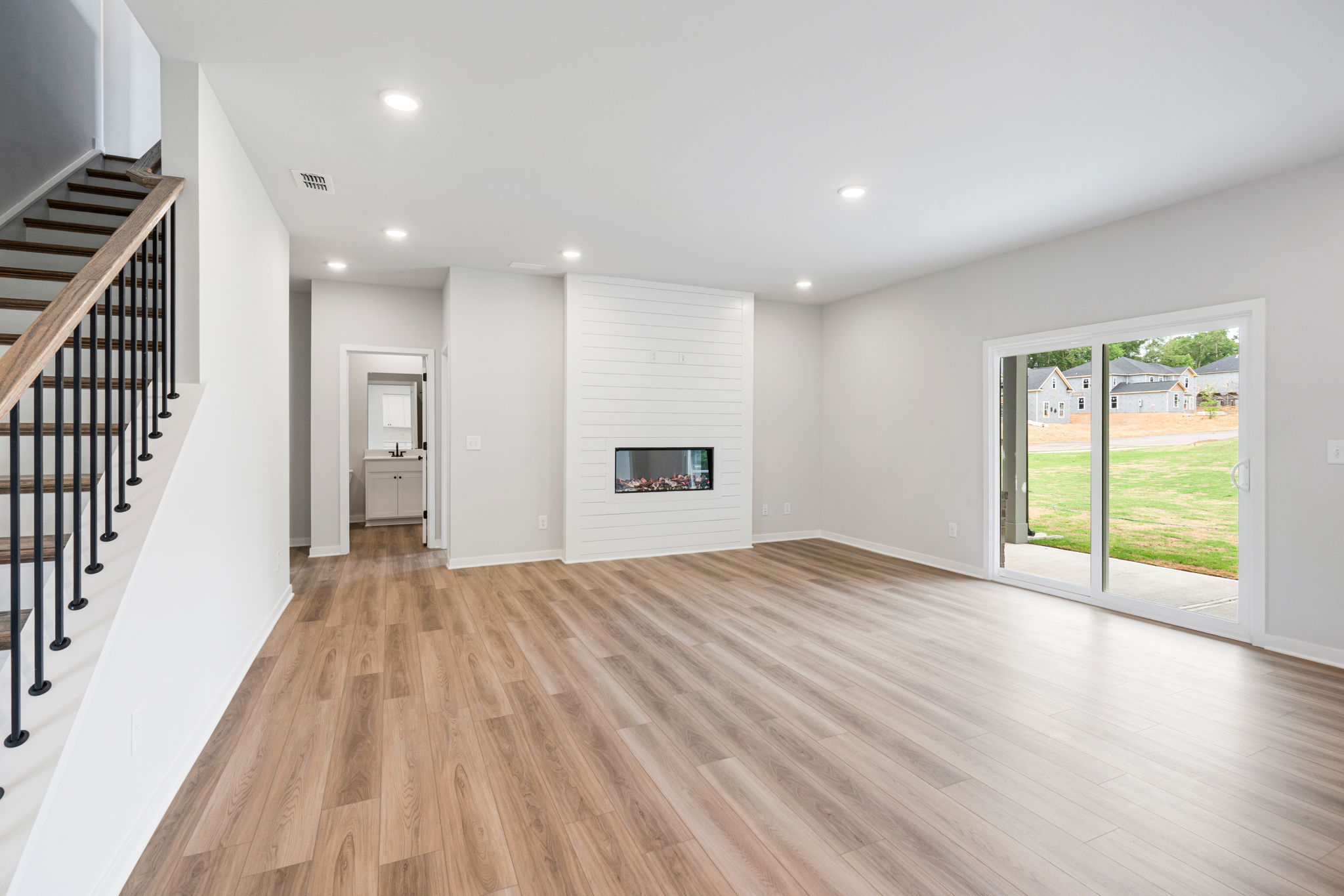 A large room with a wood floor and a wood floor.