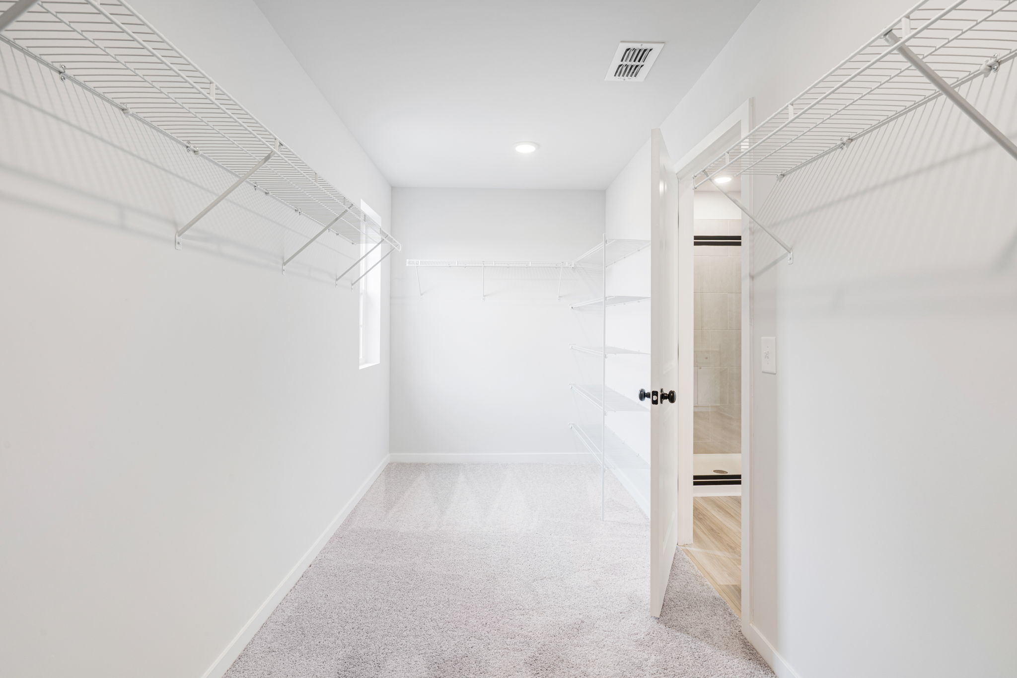 A hallway with white walls.