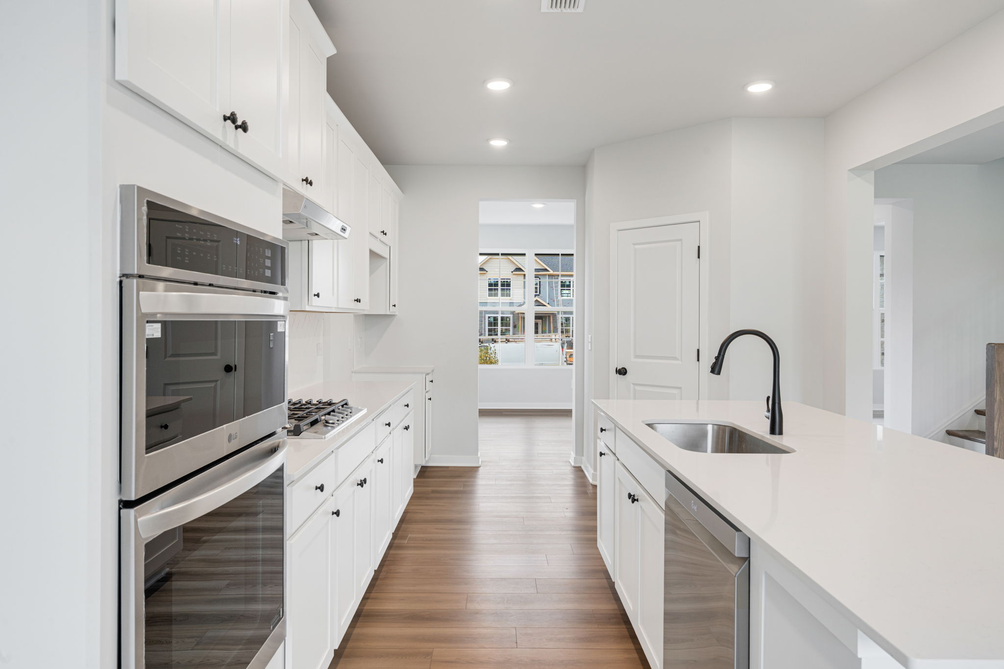 A kitchen with white cabinets.