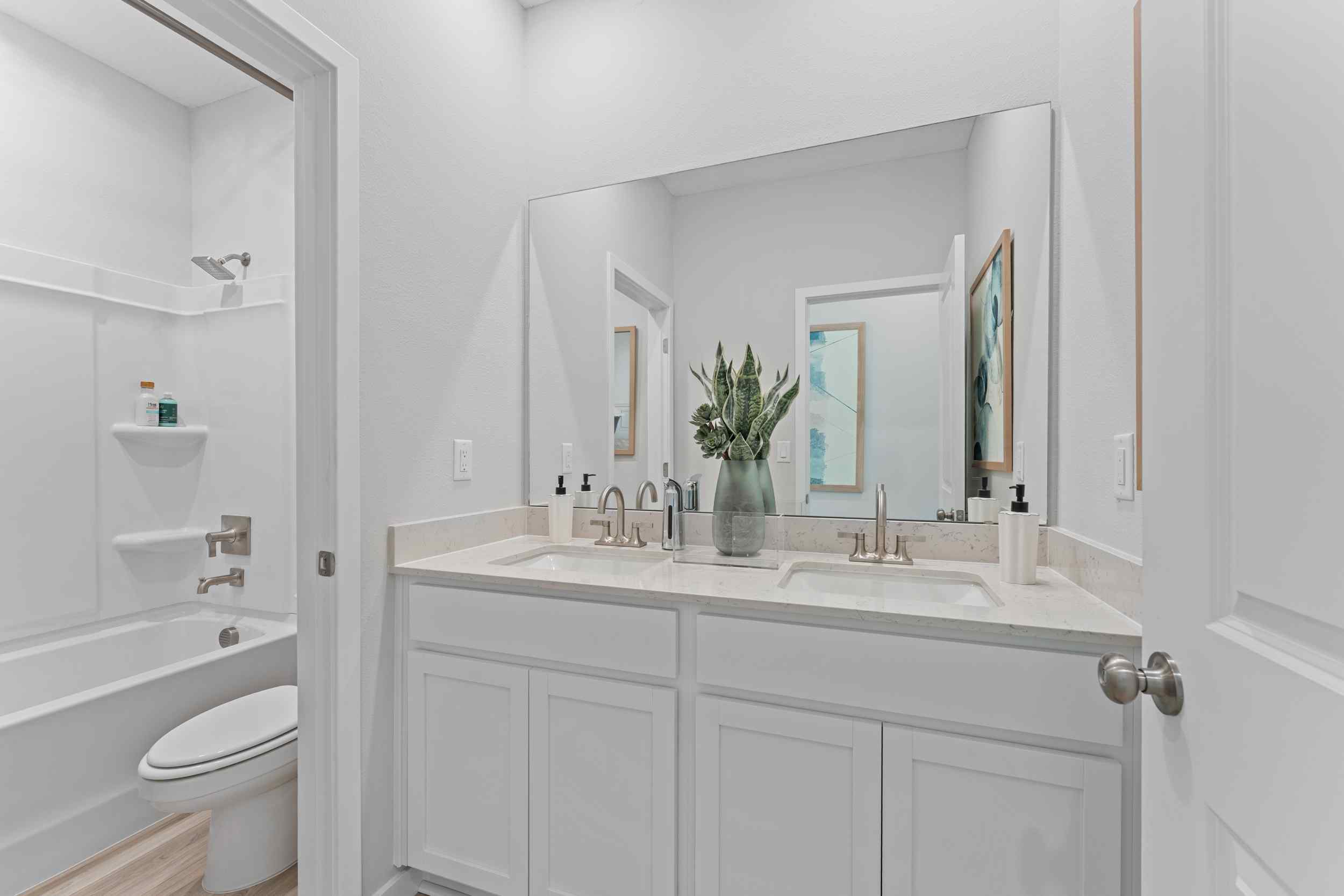 Laurel II Model Home Guest Bath with Dual Vanity Sink and Tub and Shower at Camden Woods in Kingsland, GA