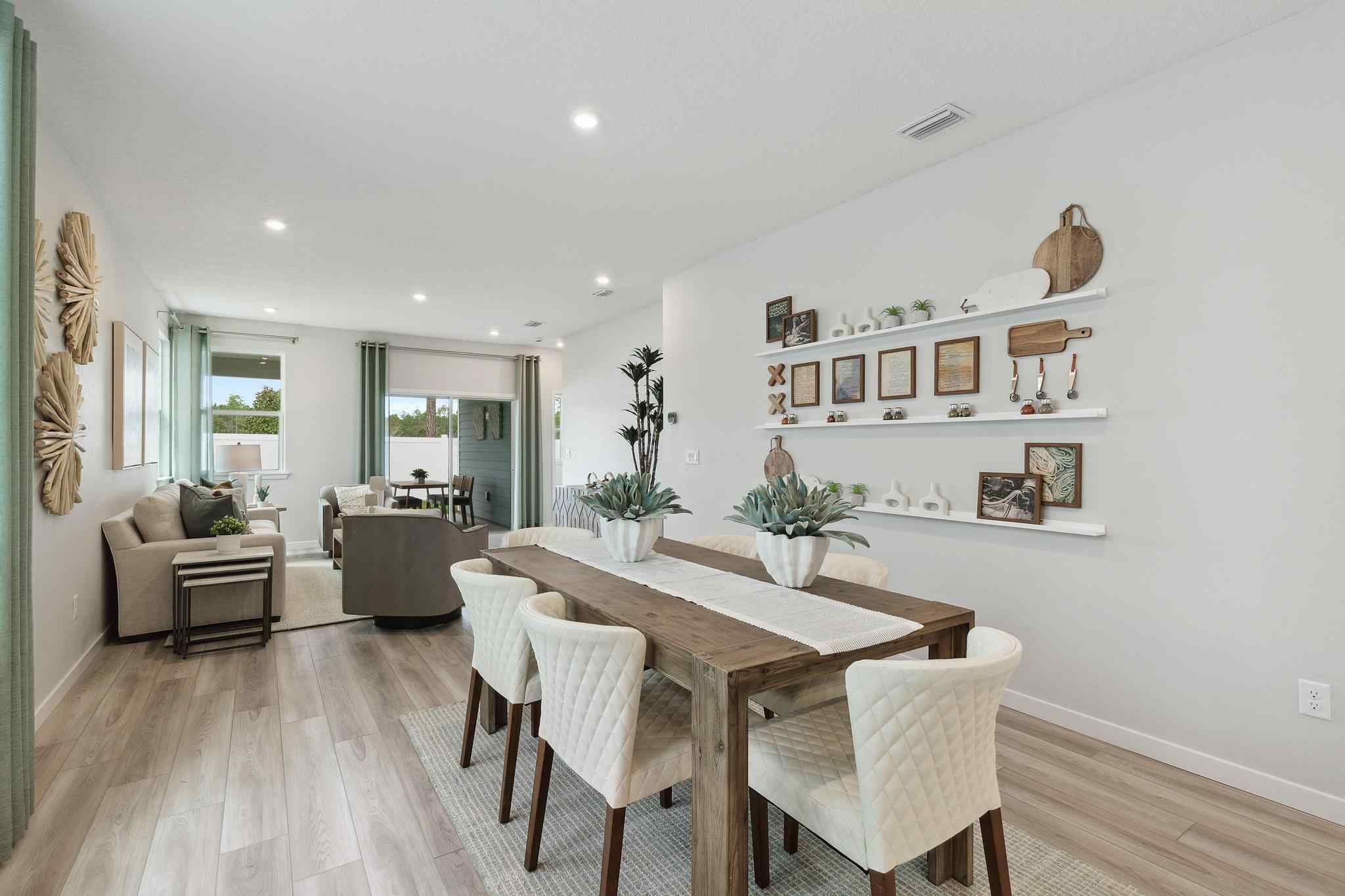 A dining room with a table and chairs.