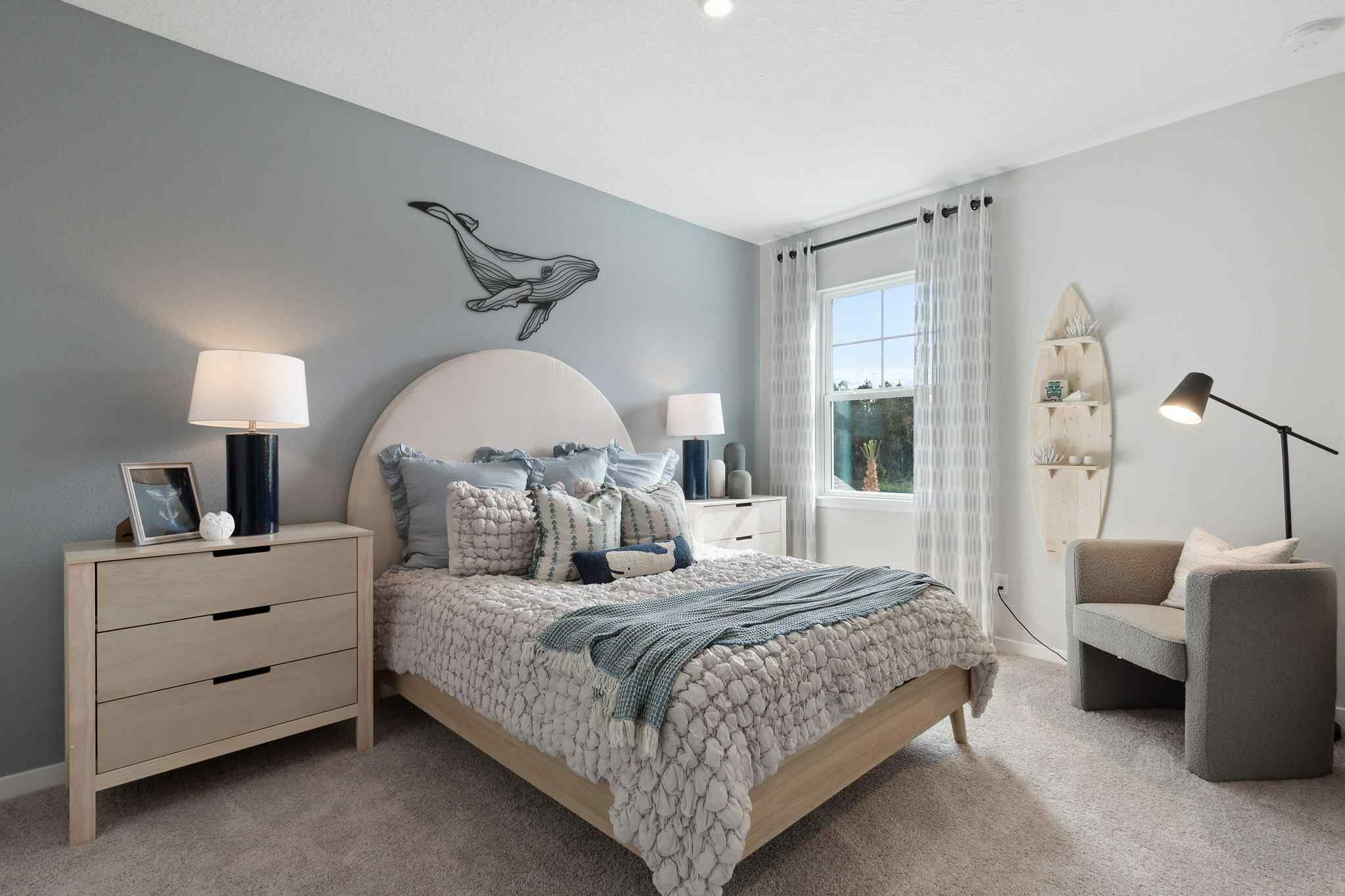 A bedroom with a bed and lamps.