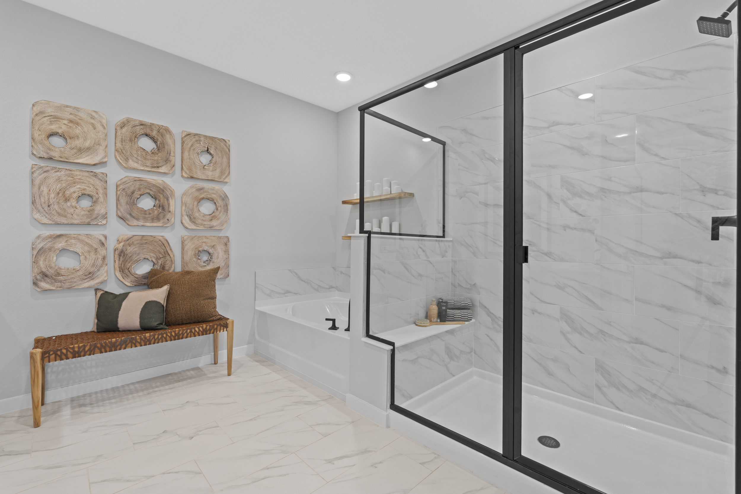 Kenai Model Home Primary Bathroom with Freestanding Tub and Glass Shower at Reserve East in Flagler Beach