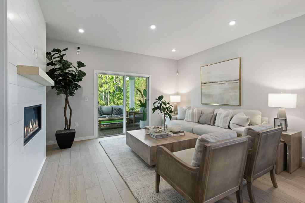 A living room with a couch and chairs.