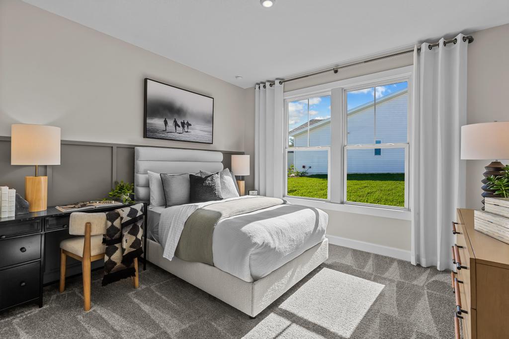 A bedroom with a large window.