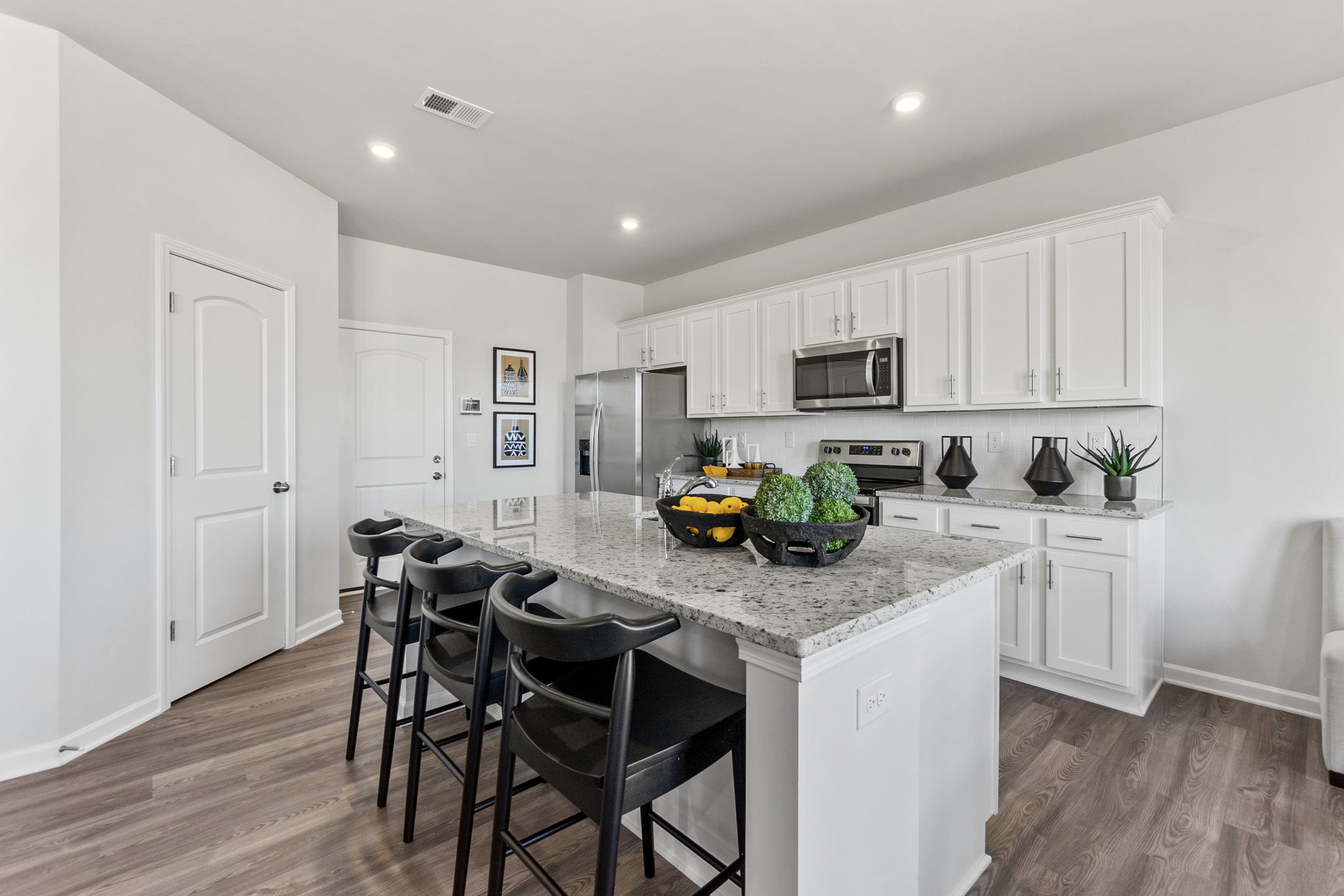 A kitchen with white cabinets.