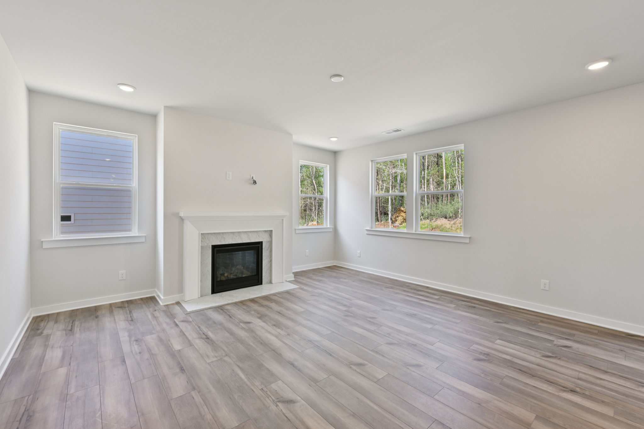 A room with a fireplace and windows.