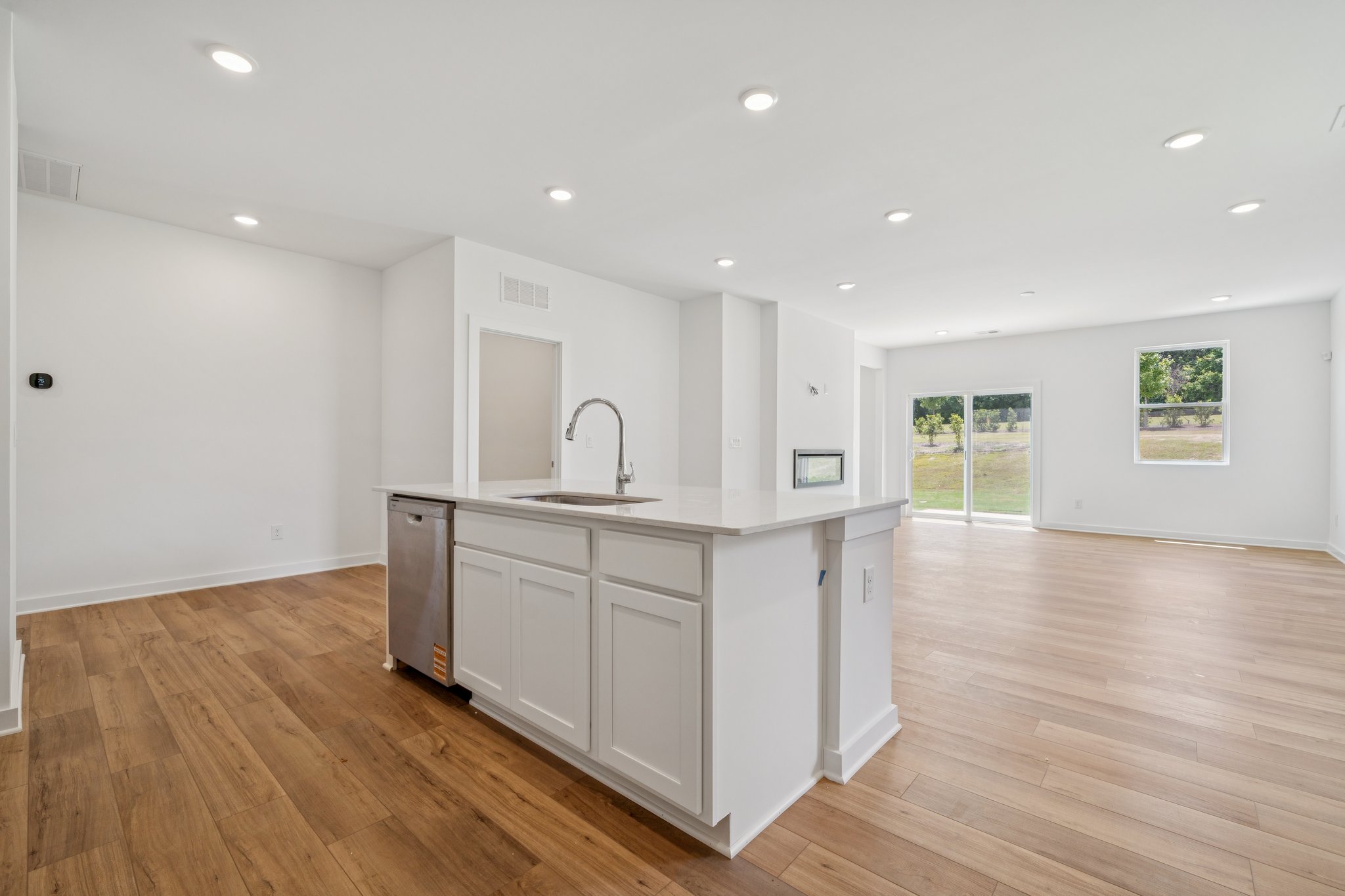 A kitchen with white cabinets.