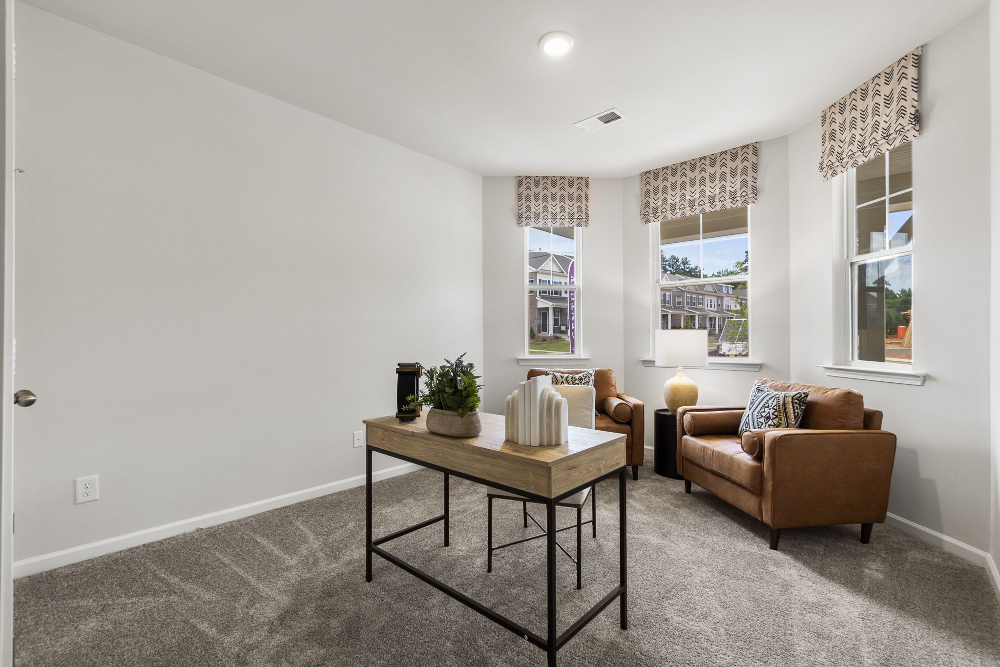 A living room with a table and chairs.