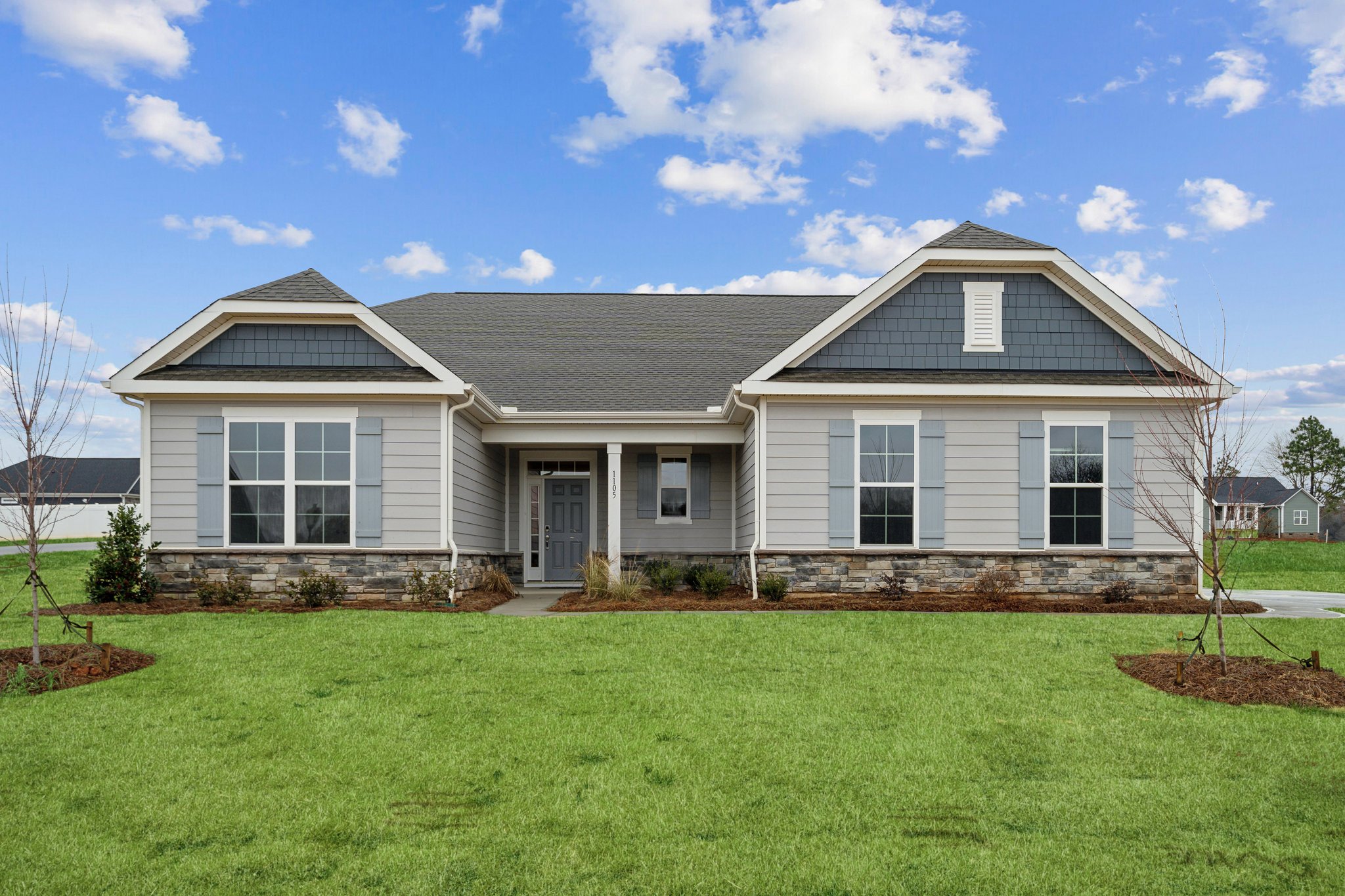 A house with a lawn in front.