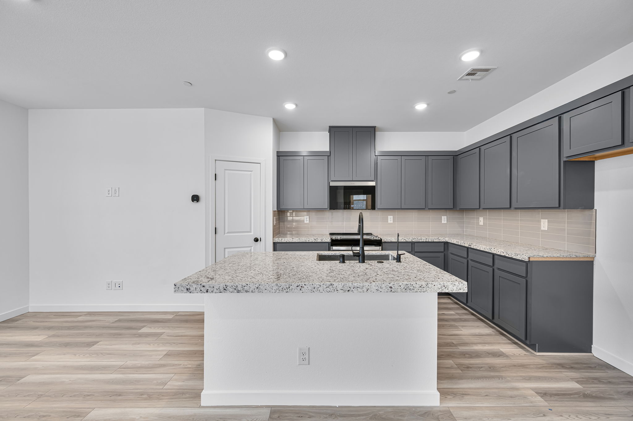 A kitchen with black cabinets.