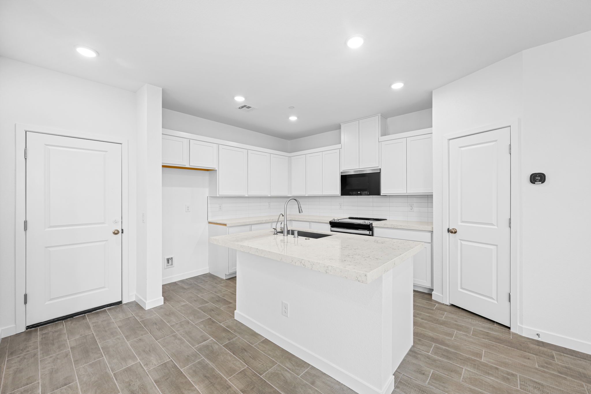 A kitchen with white cabinets.