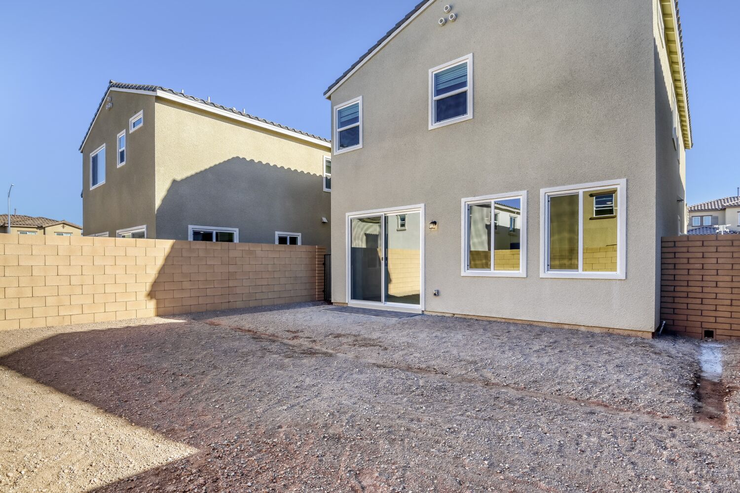 A building with a dirt yard.