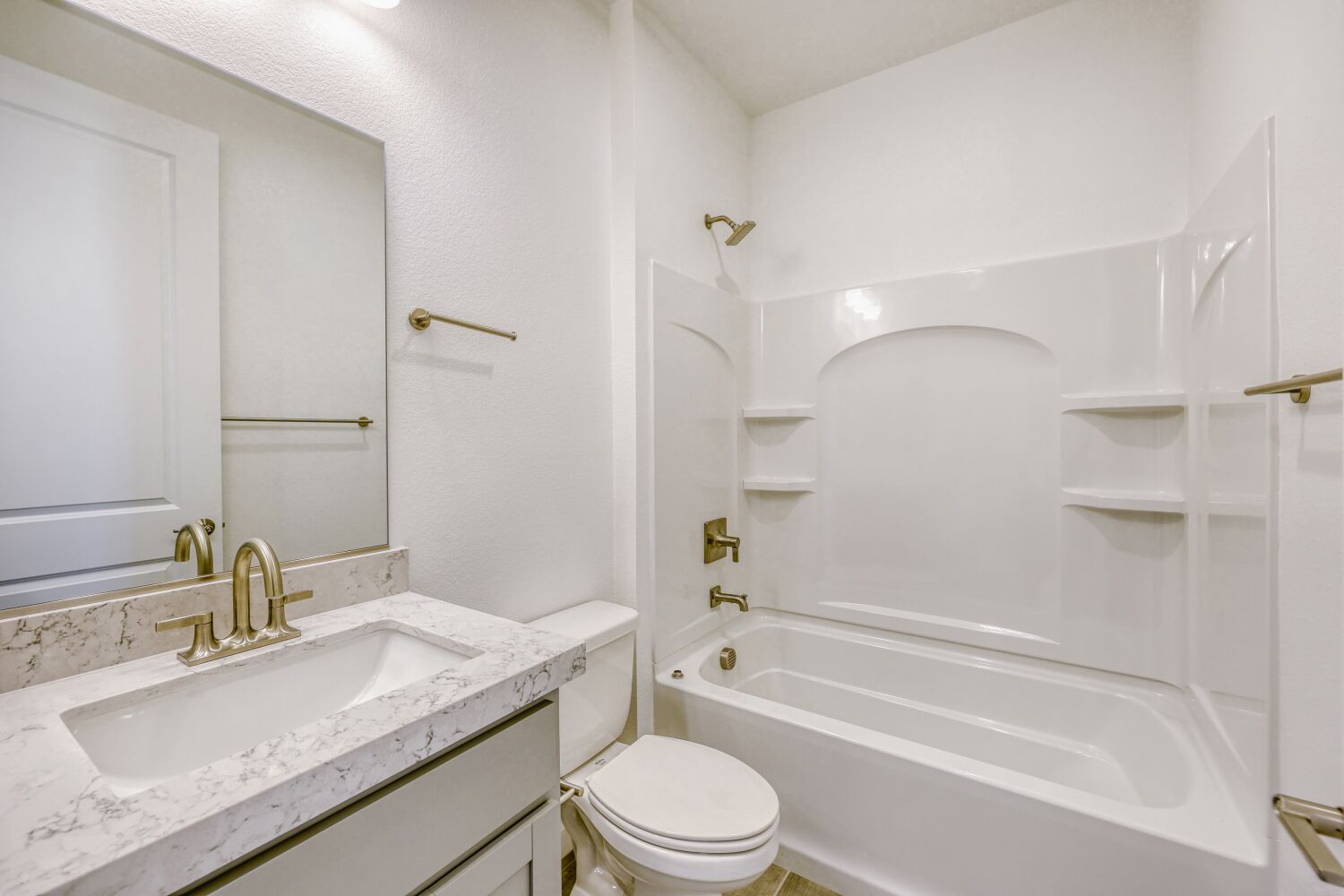 A bathroom with a tub sink and toilet.