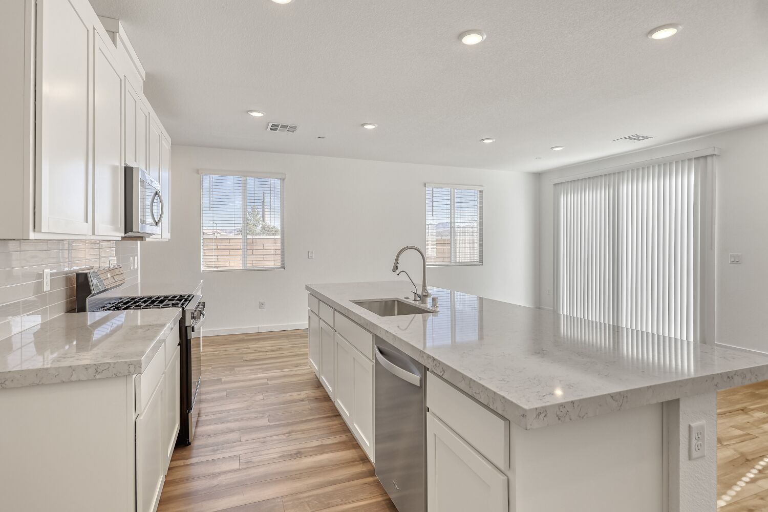 A kitchen with white cabinets.