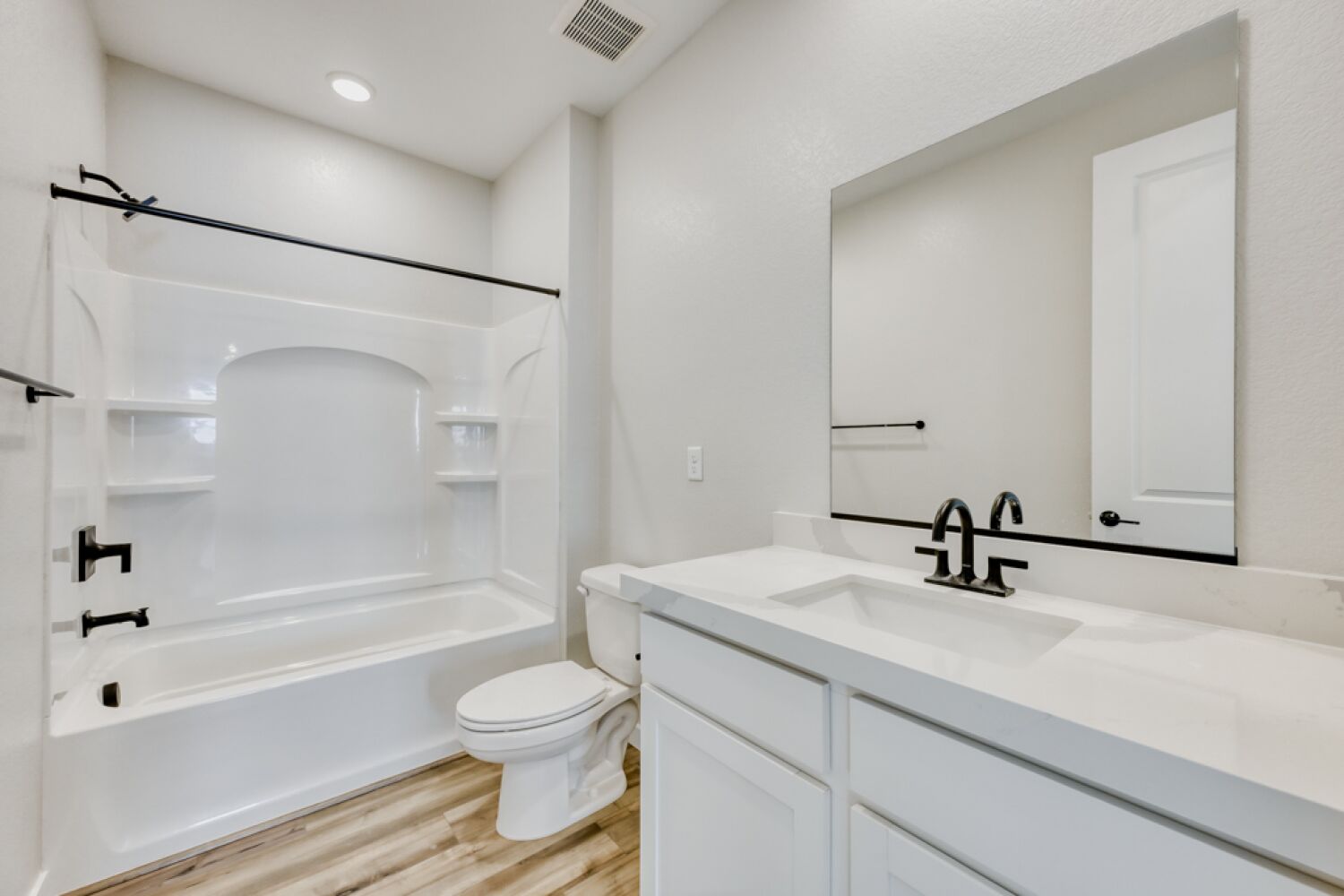 A bathroom with a tub sink and toilet.